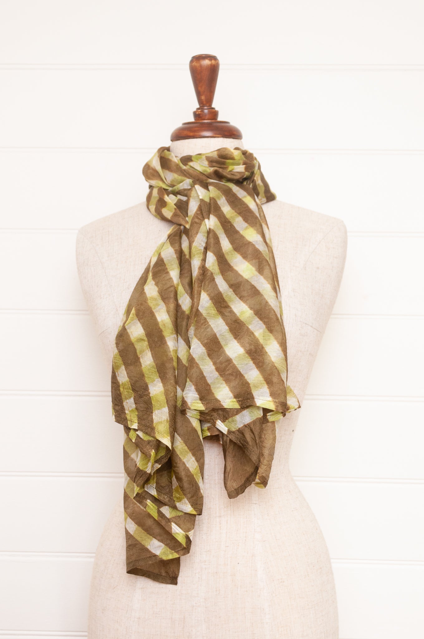 Hand painted pure silk scarf with deep olive green checks on white.