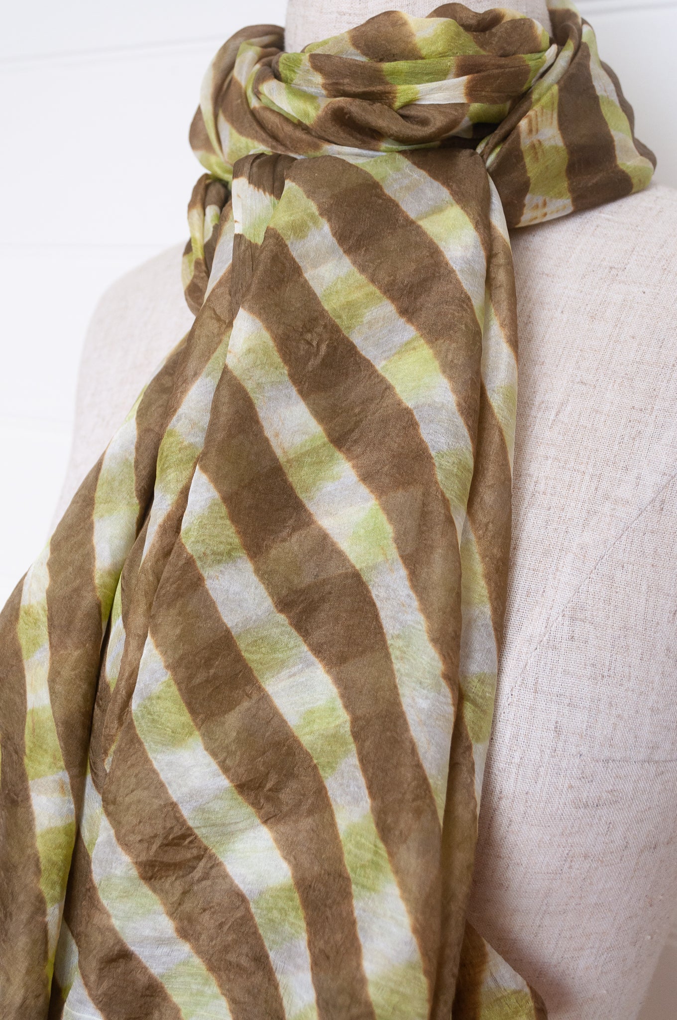 Hand painted pure silk scarf with deep olive green checks on white.