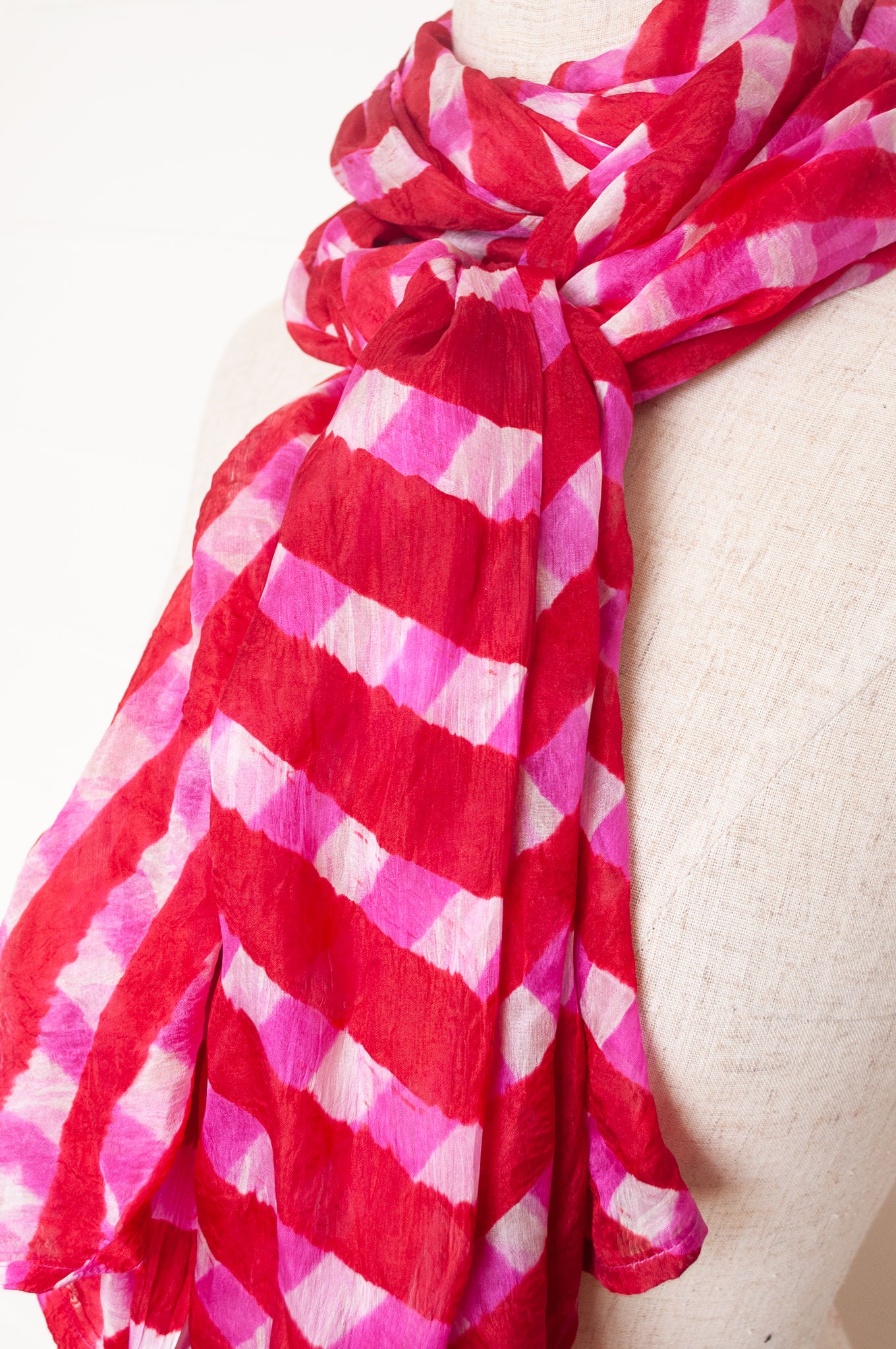 Hand painted pure silk scarf with deep red and pink checks on white.