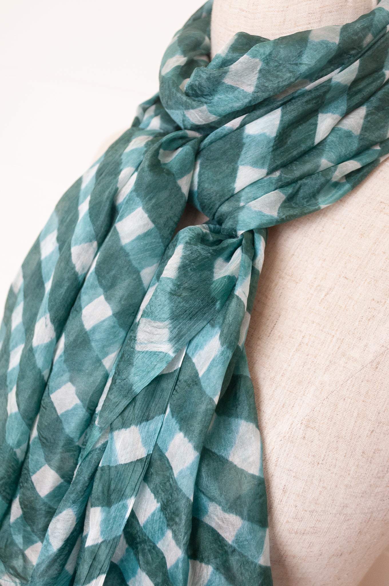 Hand painted pure silk scarf with deep turquoise green checks on white.