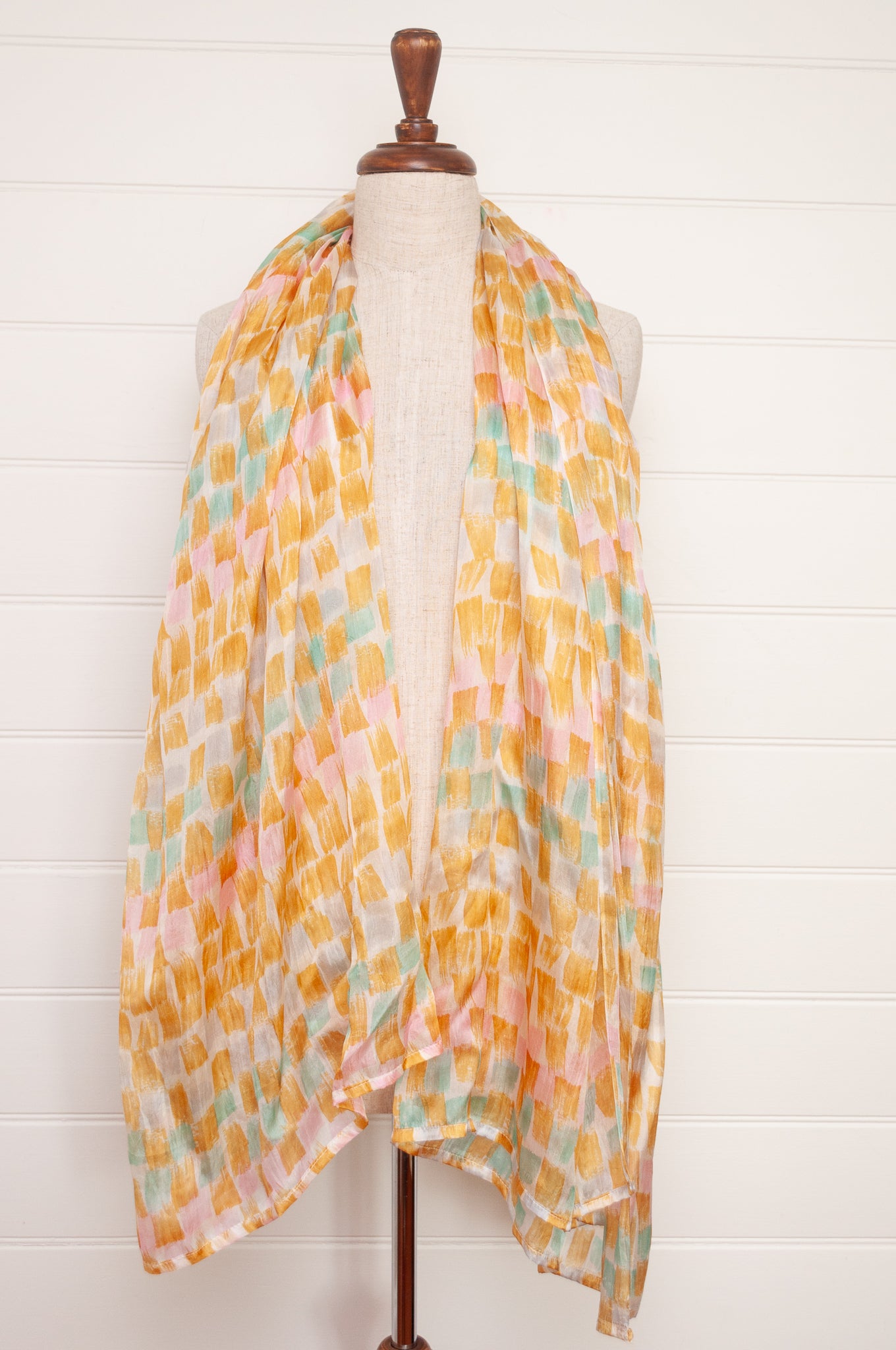 Hand painted pure silk scarf with light mustard pink and aqua blue brushstrokes on white.