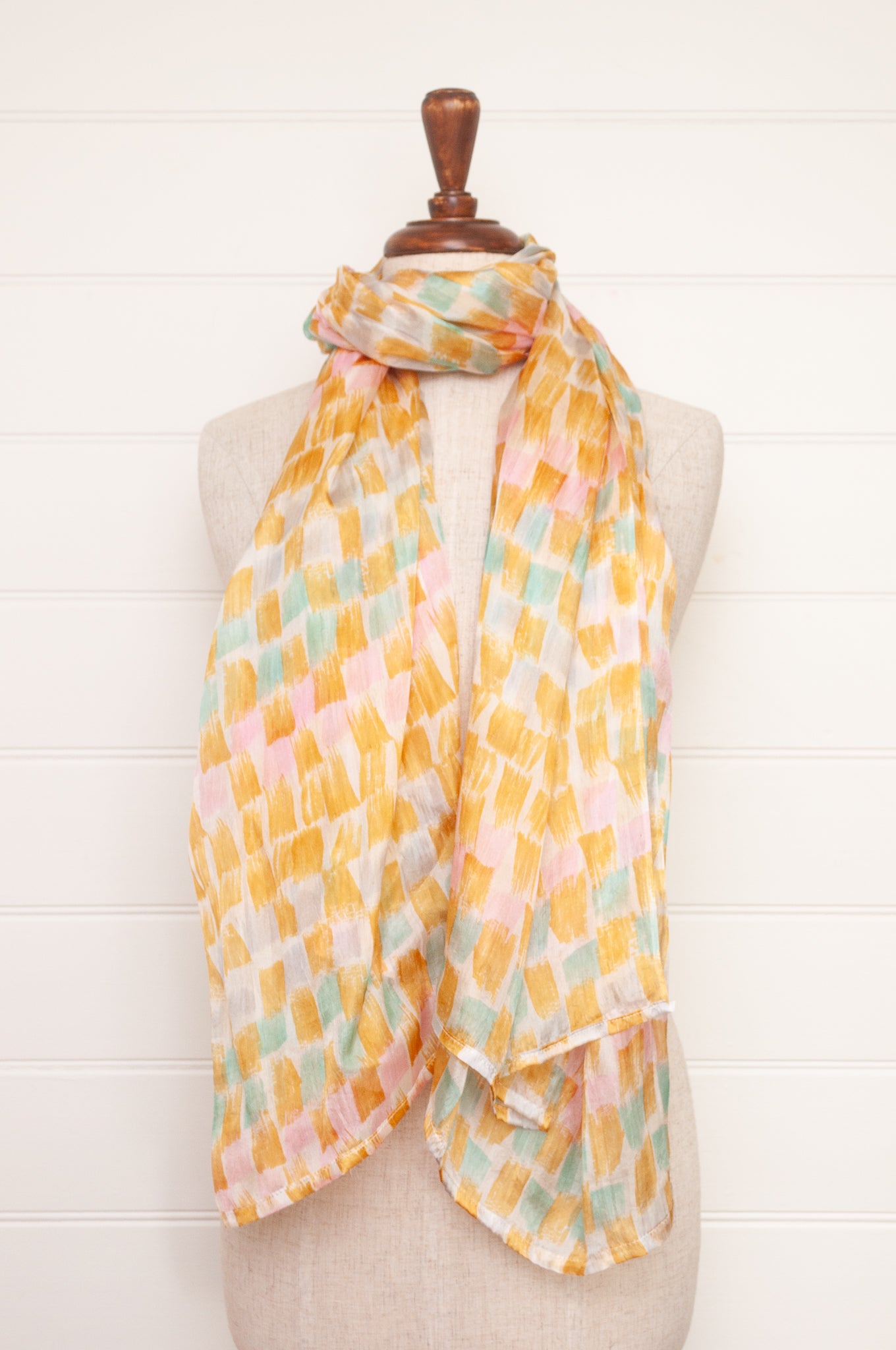 Hand painted pure silk scarf with light mustard pink and aqua blue brushstrokes on white.