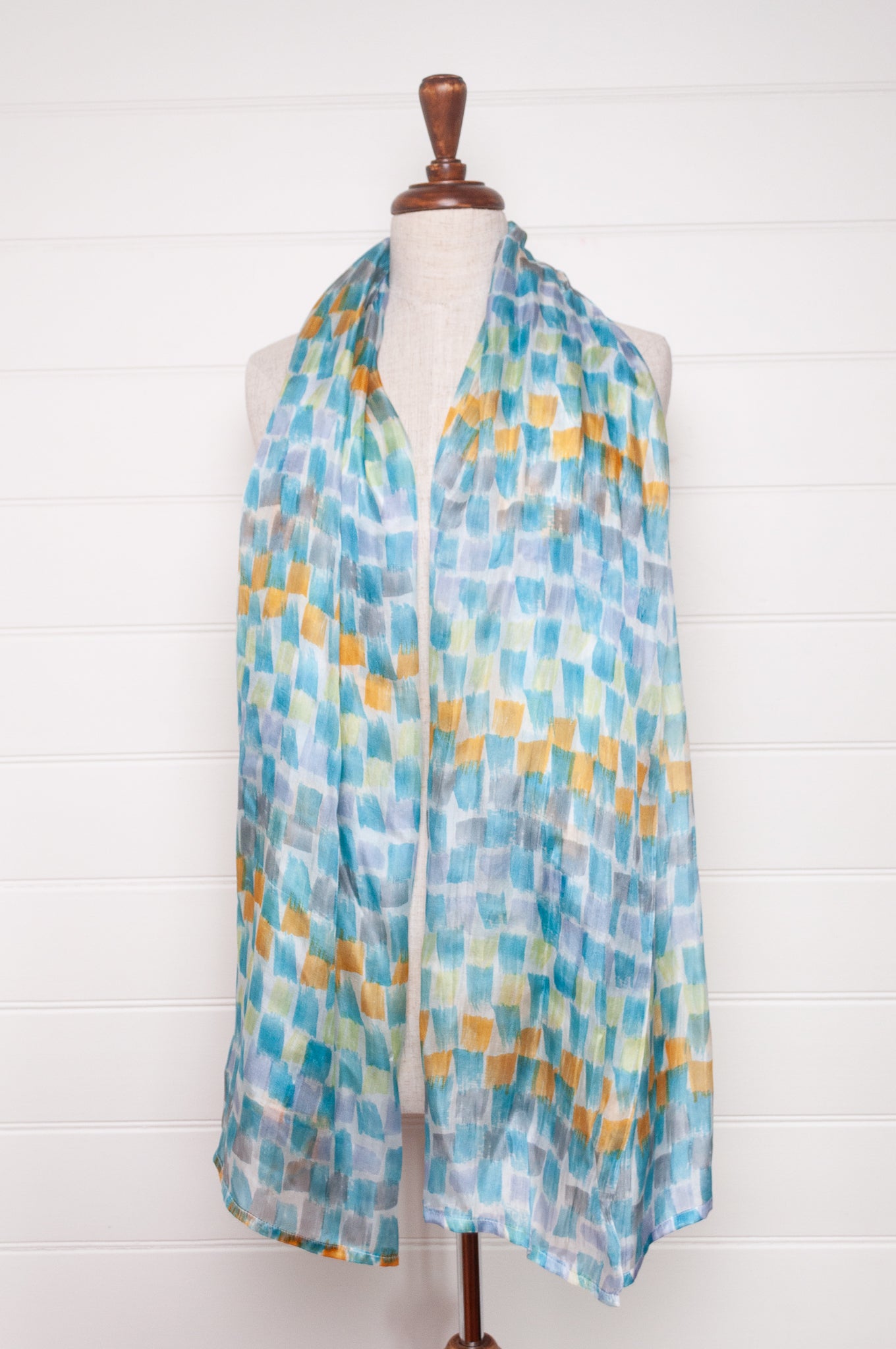 Hand painted pure silk scarf with aqua and gold brushstrokes on white.