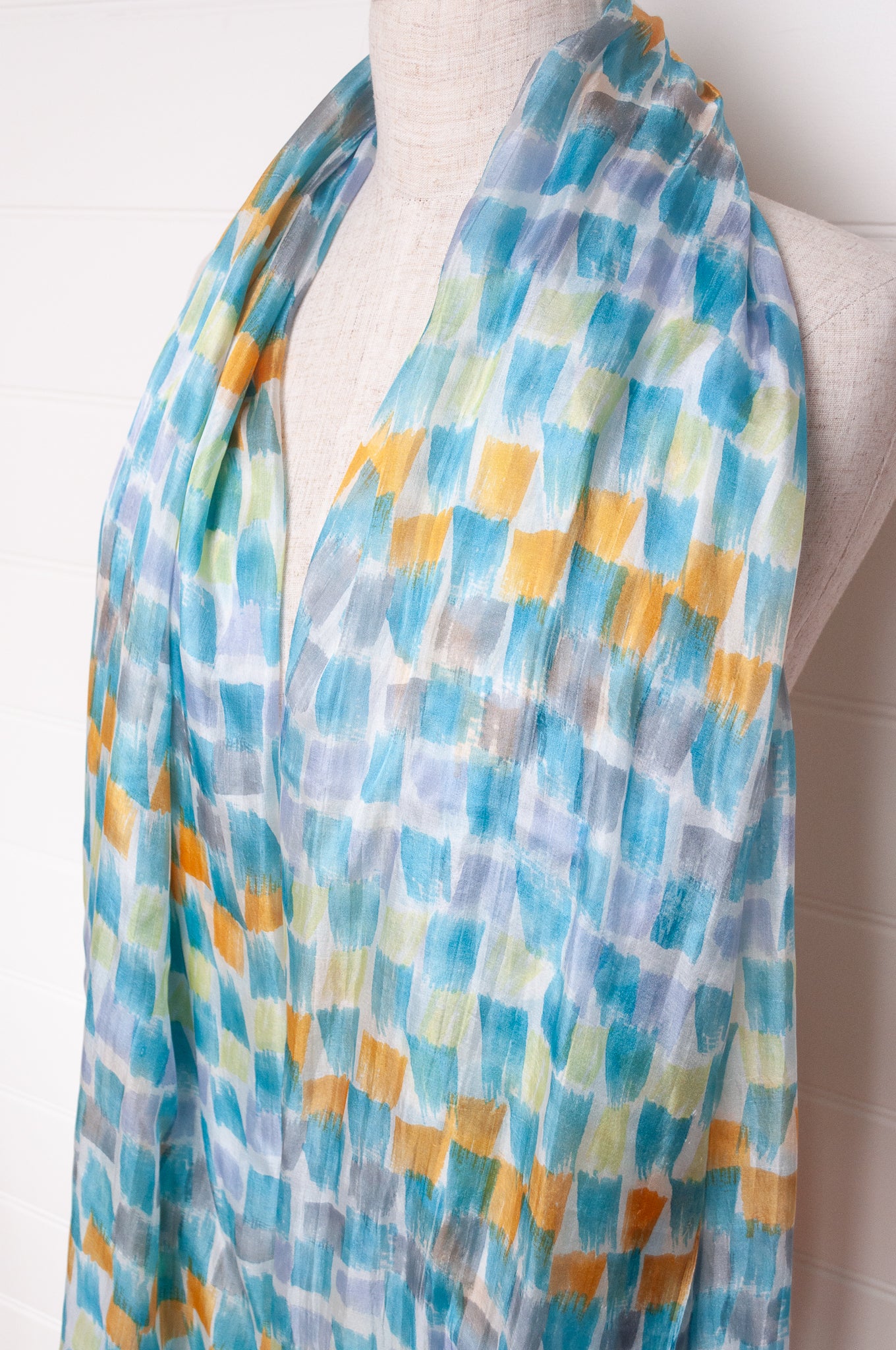 Hand painted pure silk scarf with aqua and gold brushstrokes on white.