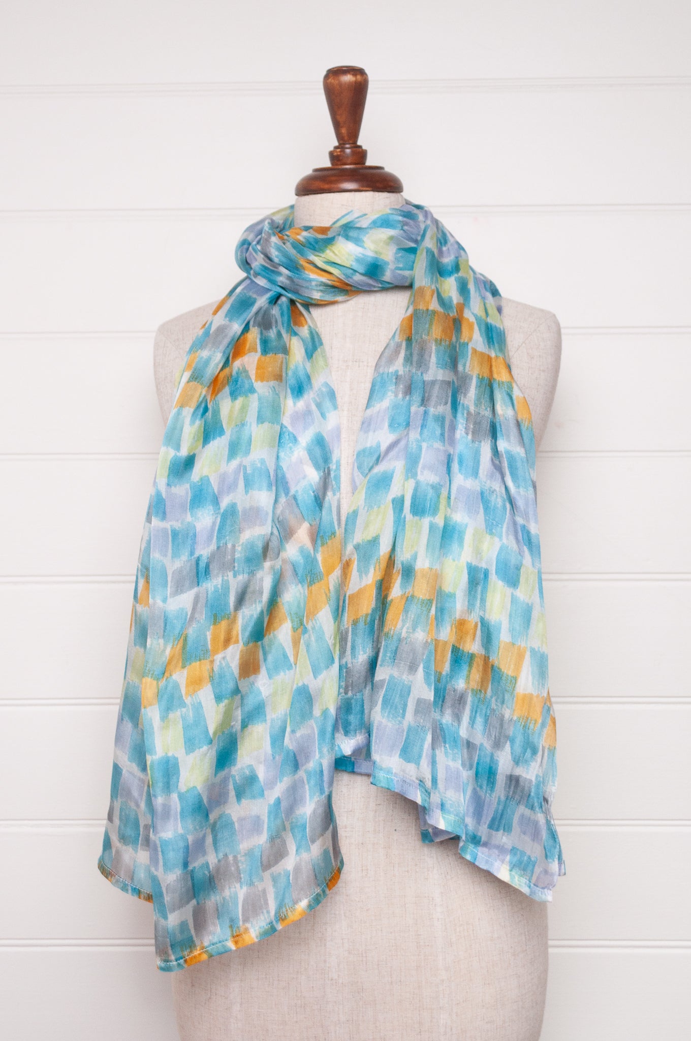 Hand painted pure silk scarf with aqua and gold brushstrokes on white.