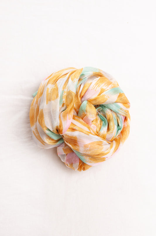 Hand painted pure silk scarf with light mustard pink and aqua blue brushstrokes on white.