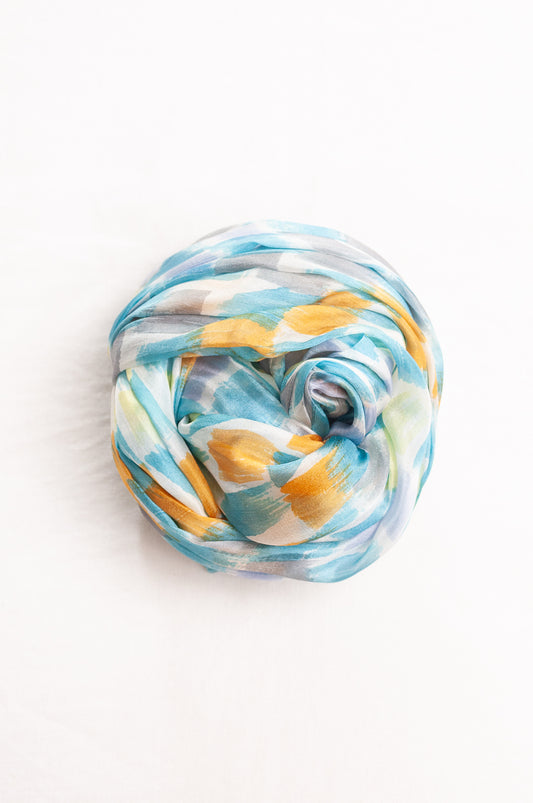 Hand painted pure silk scarf with aqua and gold brushstrokes on white.