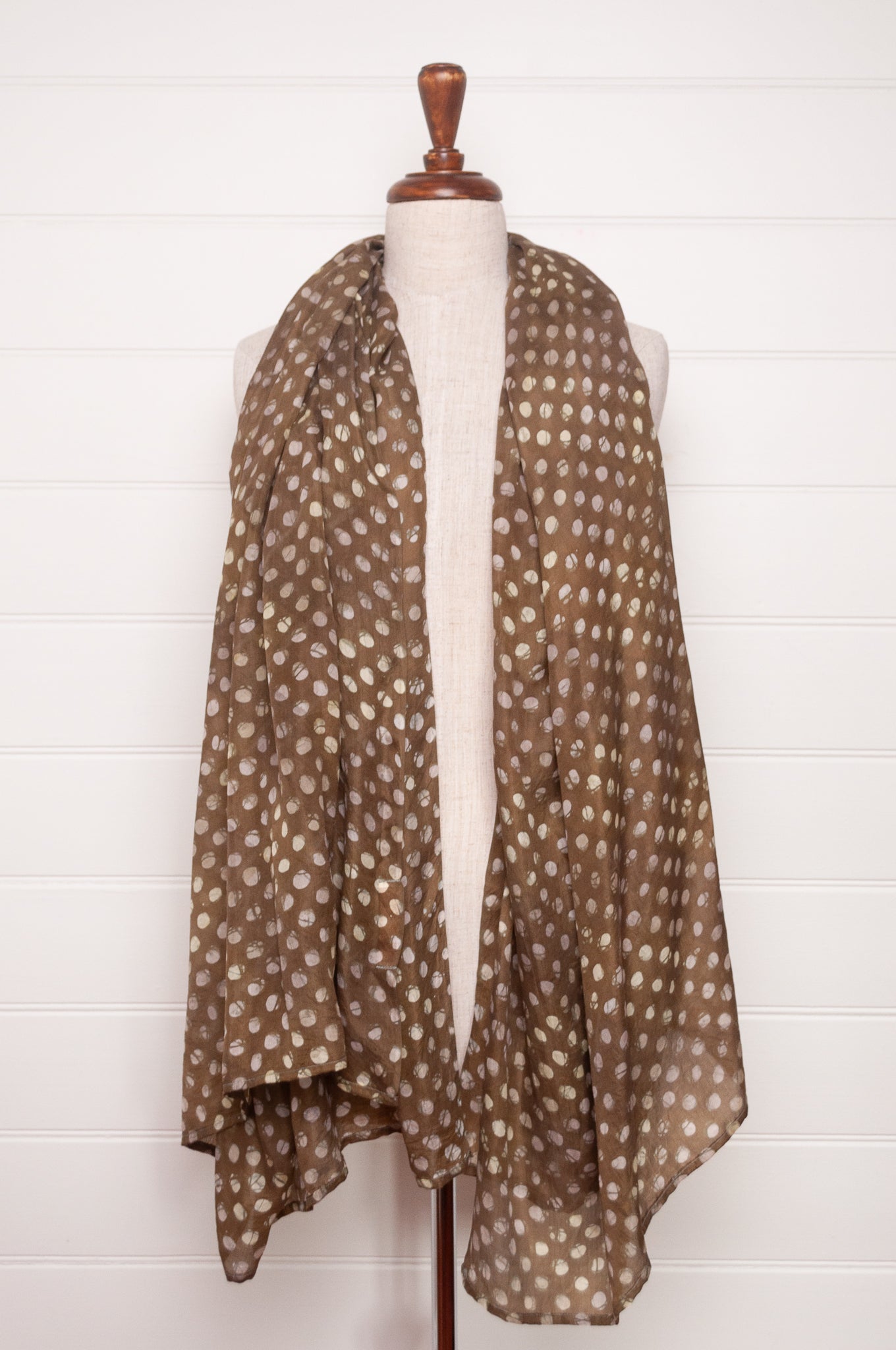 Pure silk shibori dyed  scarf in deep olive green with white spots.