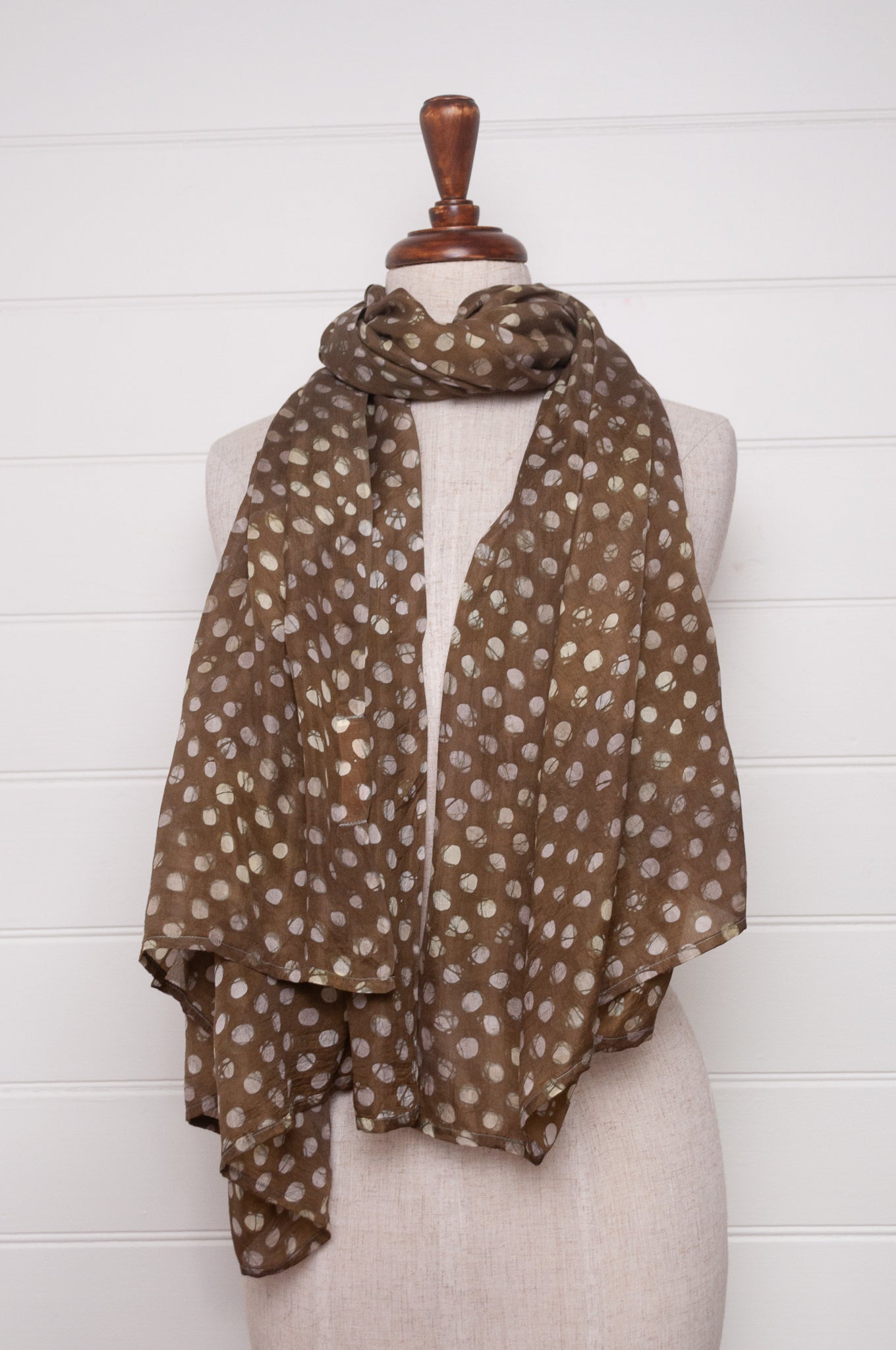 Pure silk shibori dyed  scarf in deep olive green with white spots.