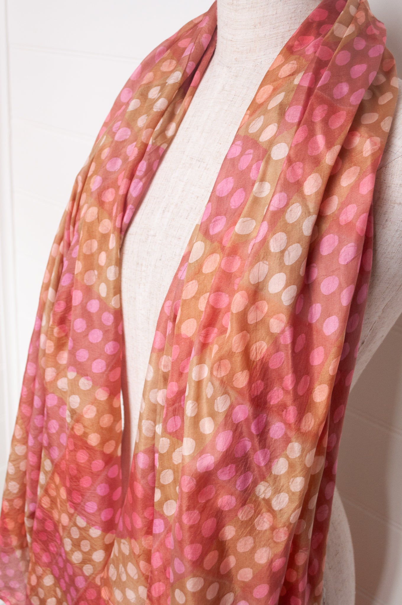 Pure silk shibori dyed  scarf in bands of pink and golden brown.