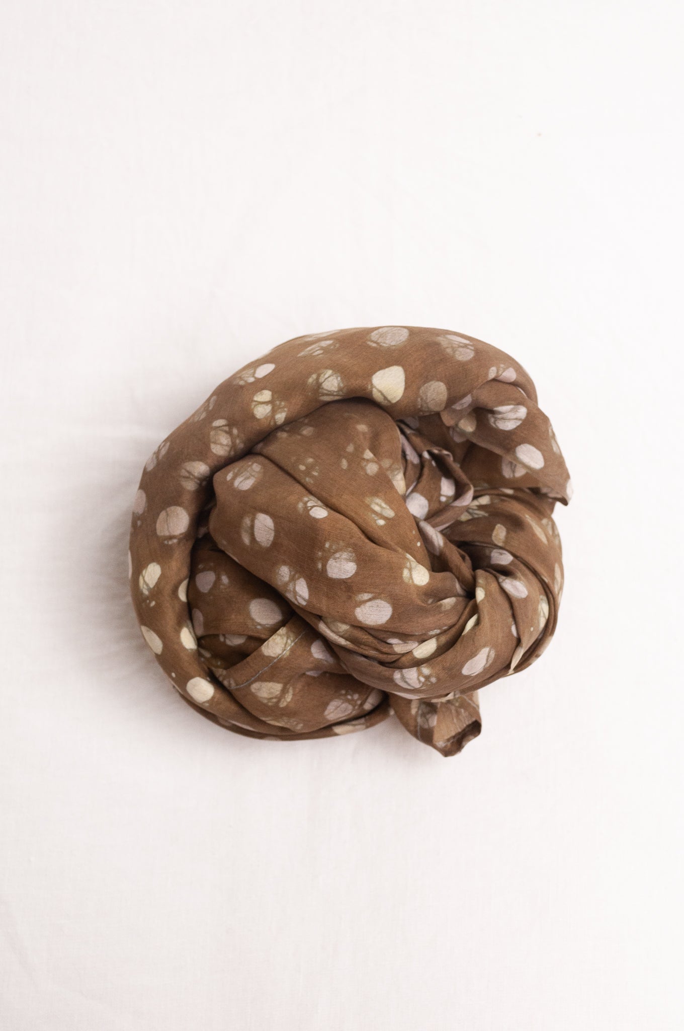 Pure silk shibori dyed  scarf in deep olive green with white spots.