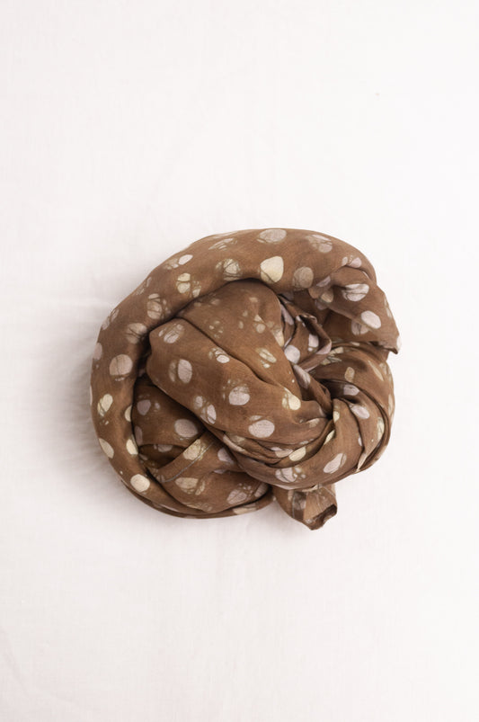 Pure silk shibori dyed  scarf in deep olive green with white spots.