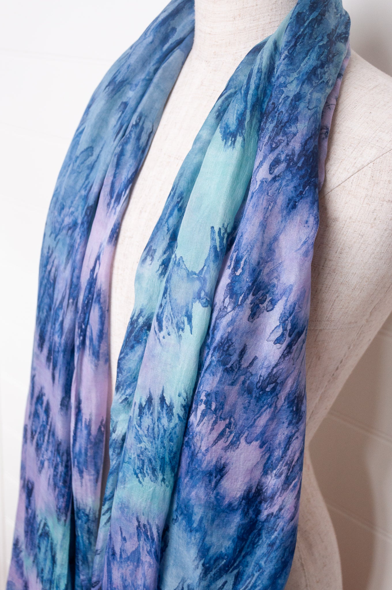 Pure silk shibori dyed scarf in shades of blue and purple.