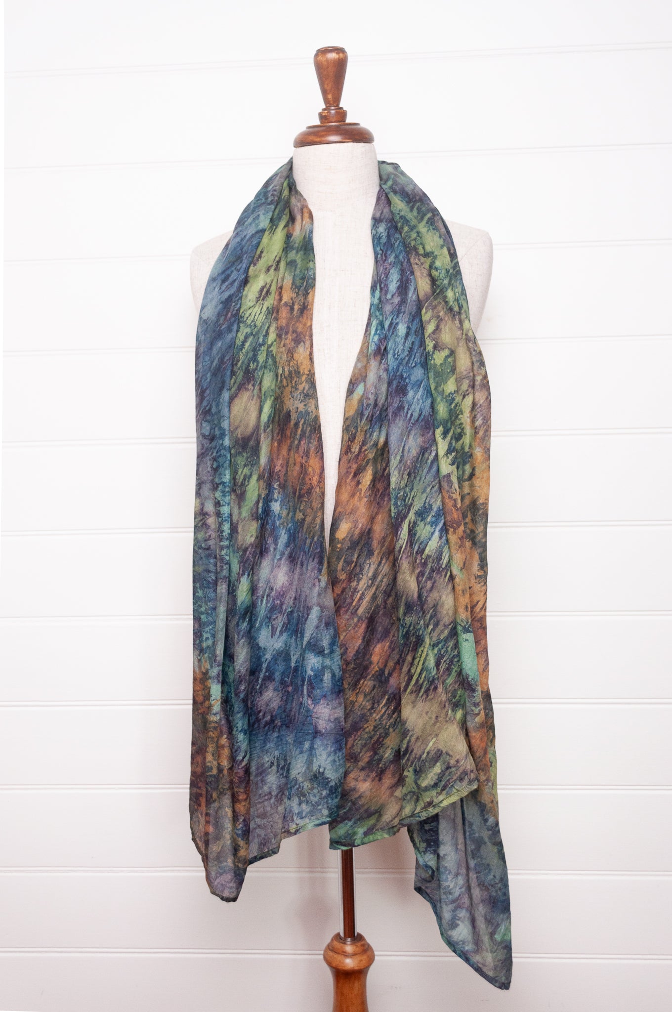 Pure silk shibori dyed scarf in shades of blues, greens and browns.