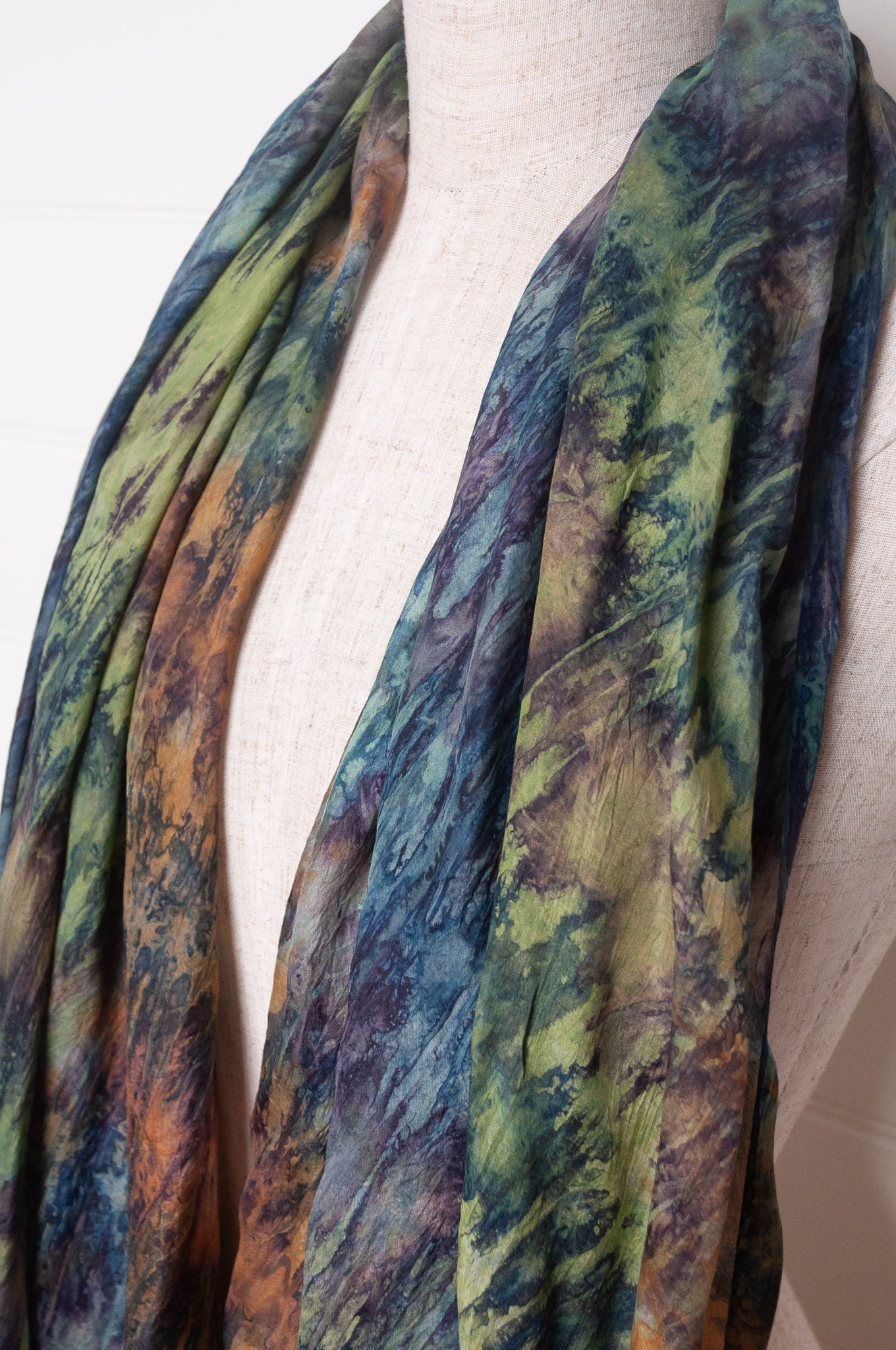 Pure silk shibori dyed scarf in shades of blues, greens and browns.
