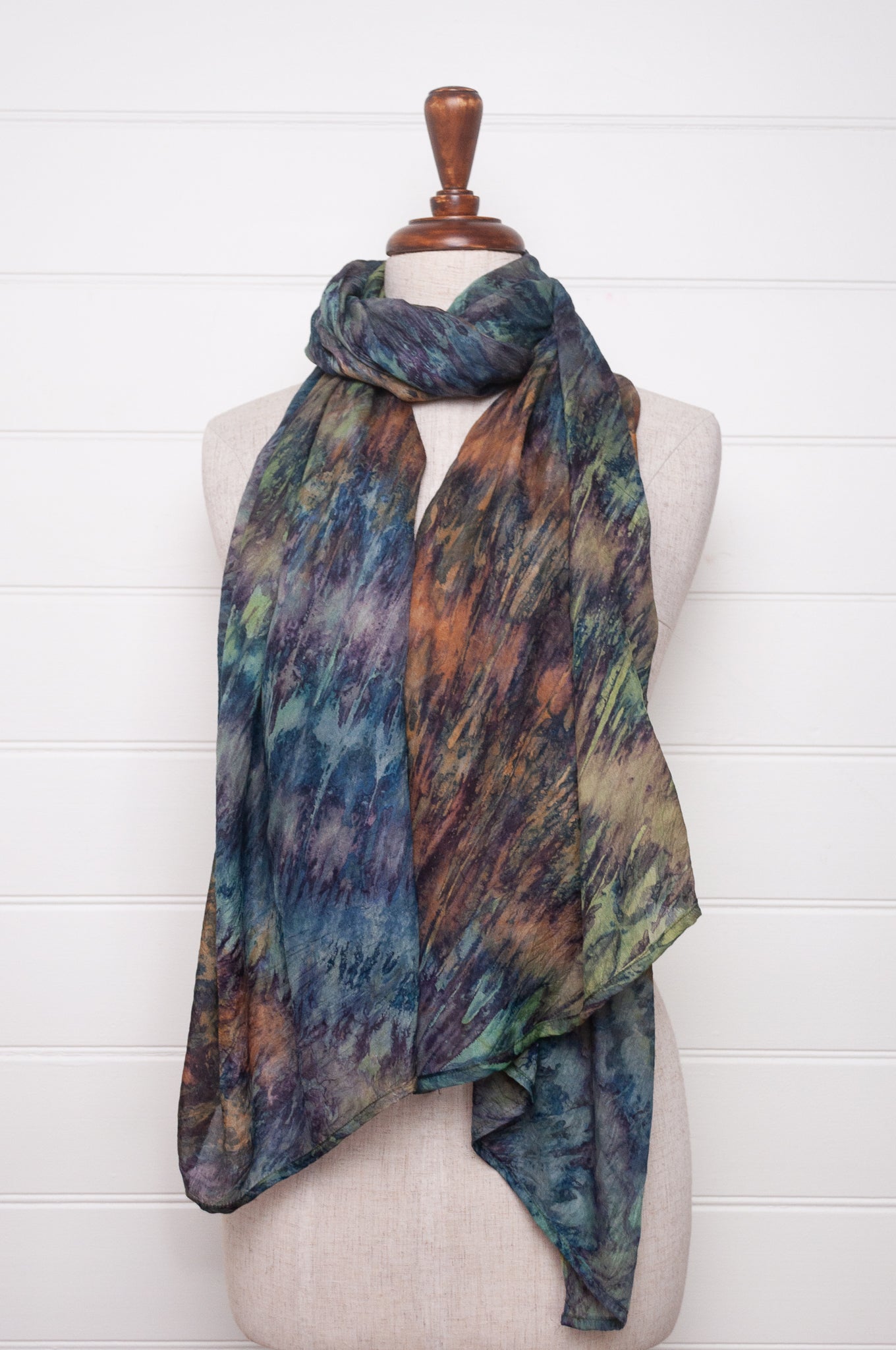 Pure silk shibori dyed scarf in shades of blues, greens and browns.