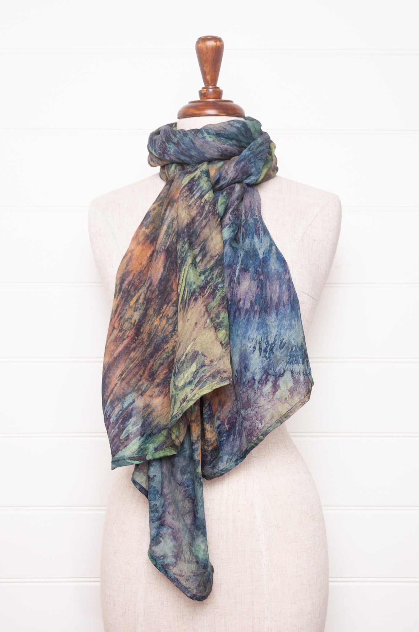 Pure silk shibori dyed scarf in shades of blues, greens and browns.