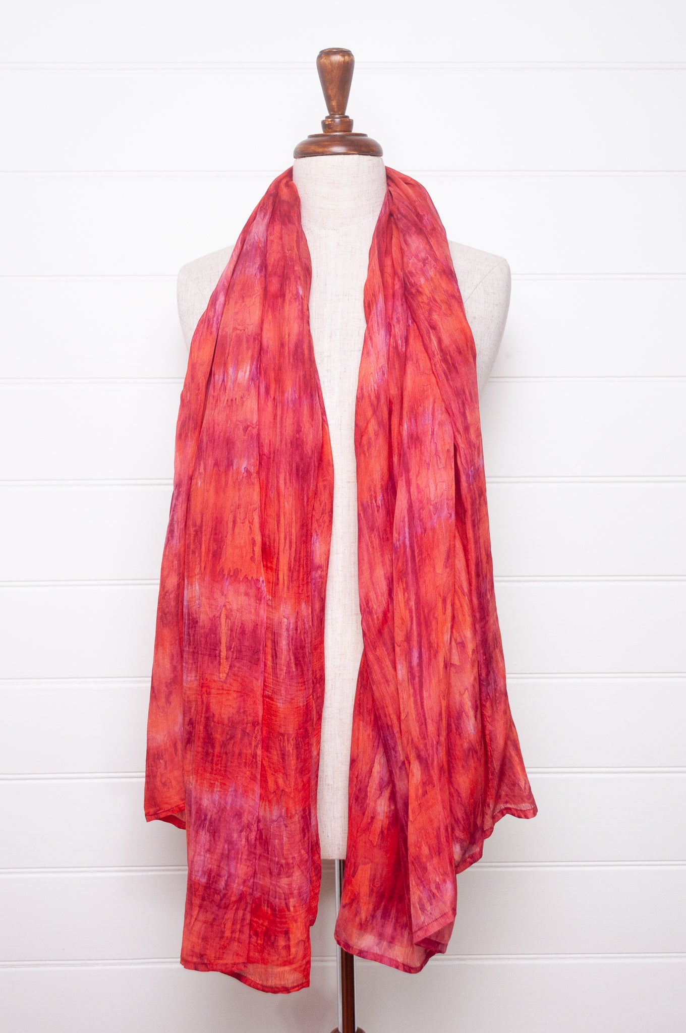 Pure silk shibori dyed scarf in shades of rose pink and red.