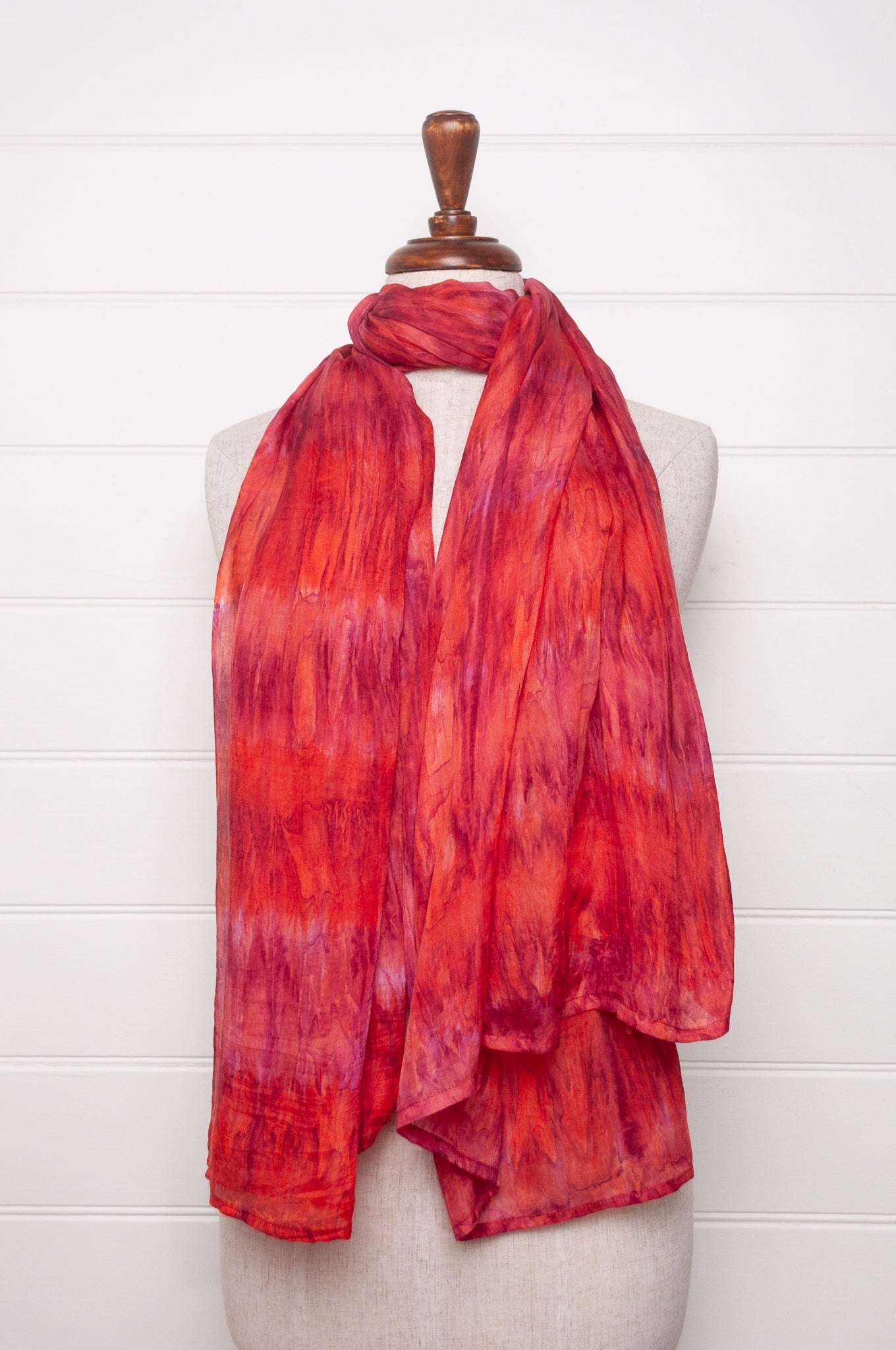 Pure silk shibori dyed scarf in shades of rose pink and red.