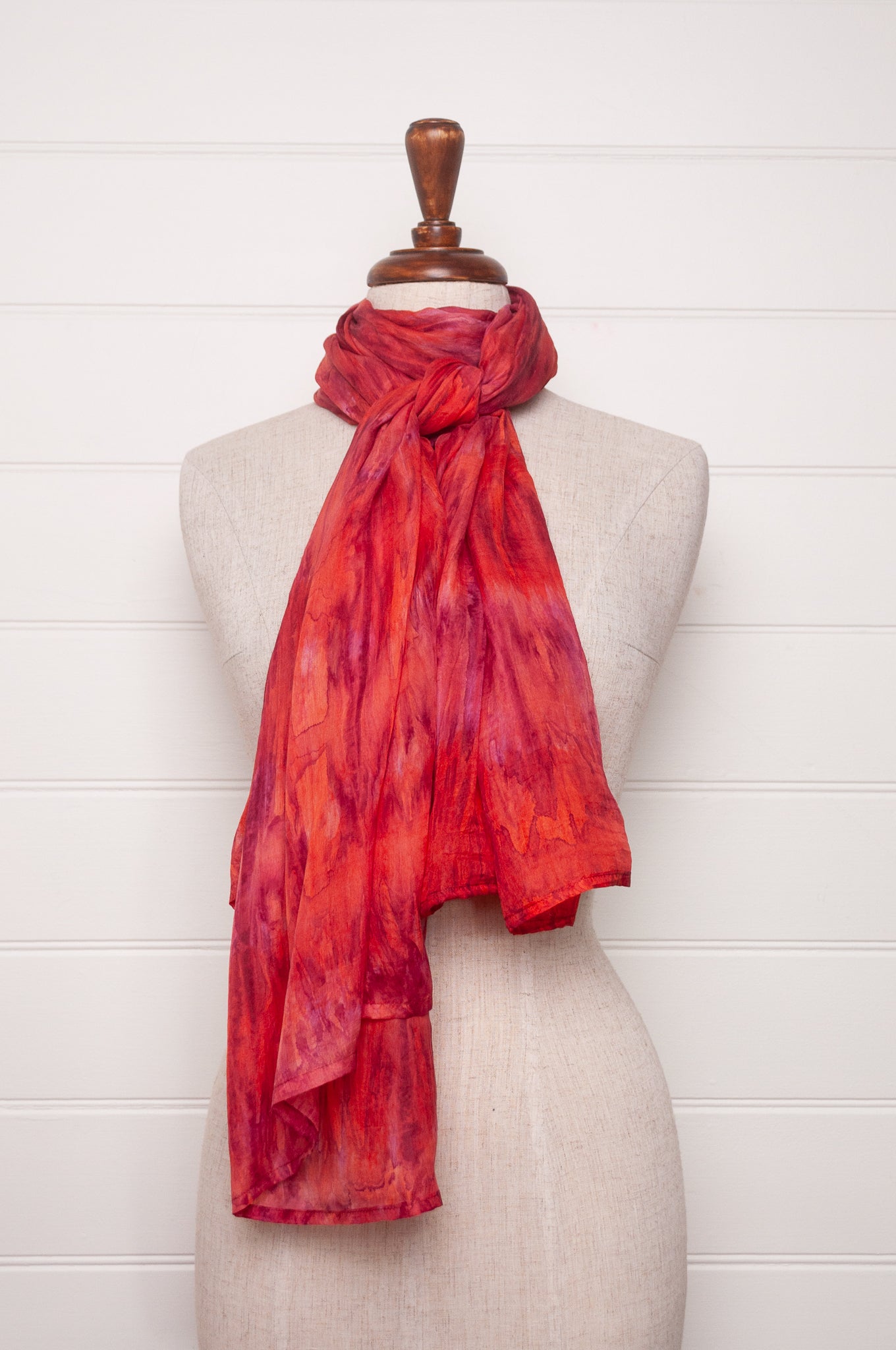 Pure silk shibori dyed scarf in shades of rose pink and red.