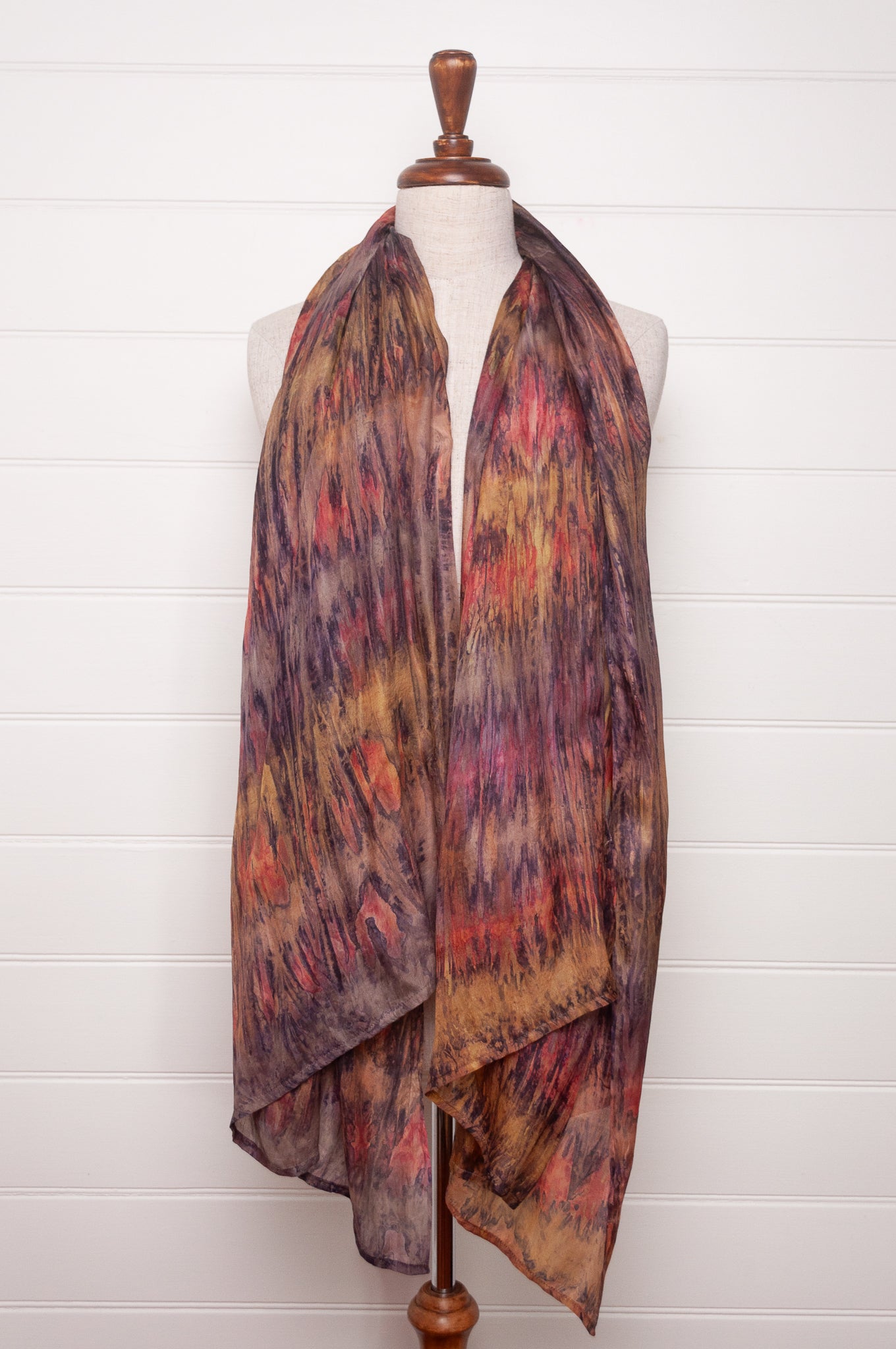 Pure silk shibori dyed scarf in shades of bronze, orange and purple.