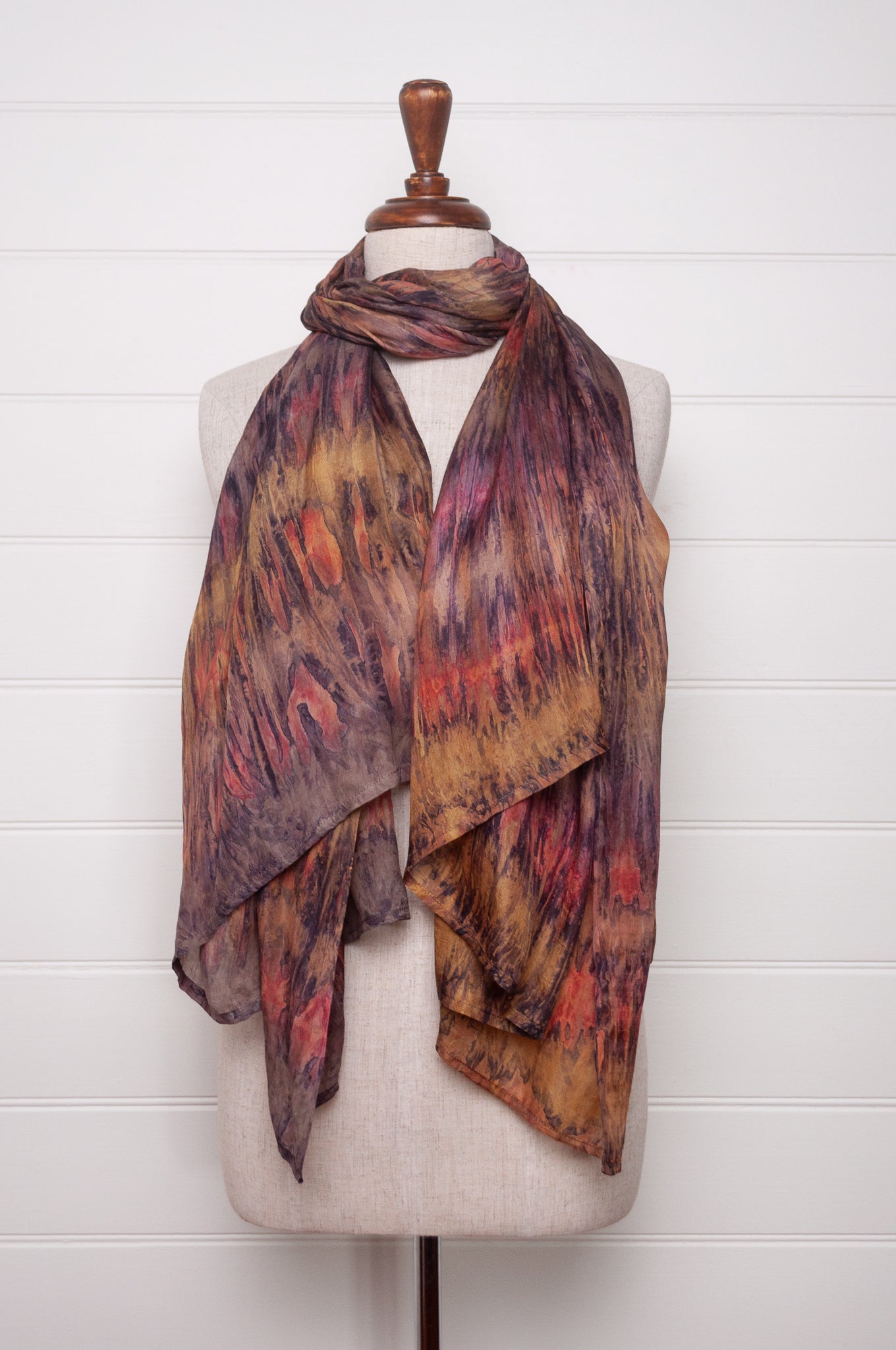 Pure silk shibori dyed scarf in shades of bronze, orange and purple.
