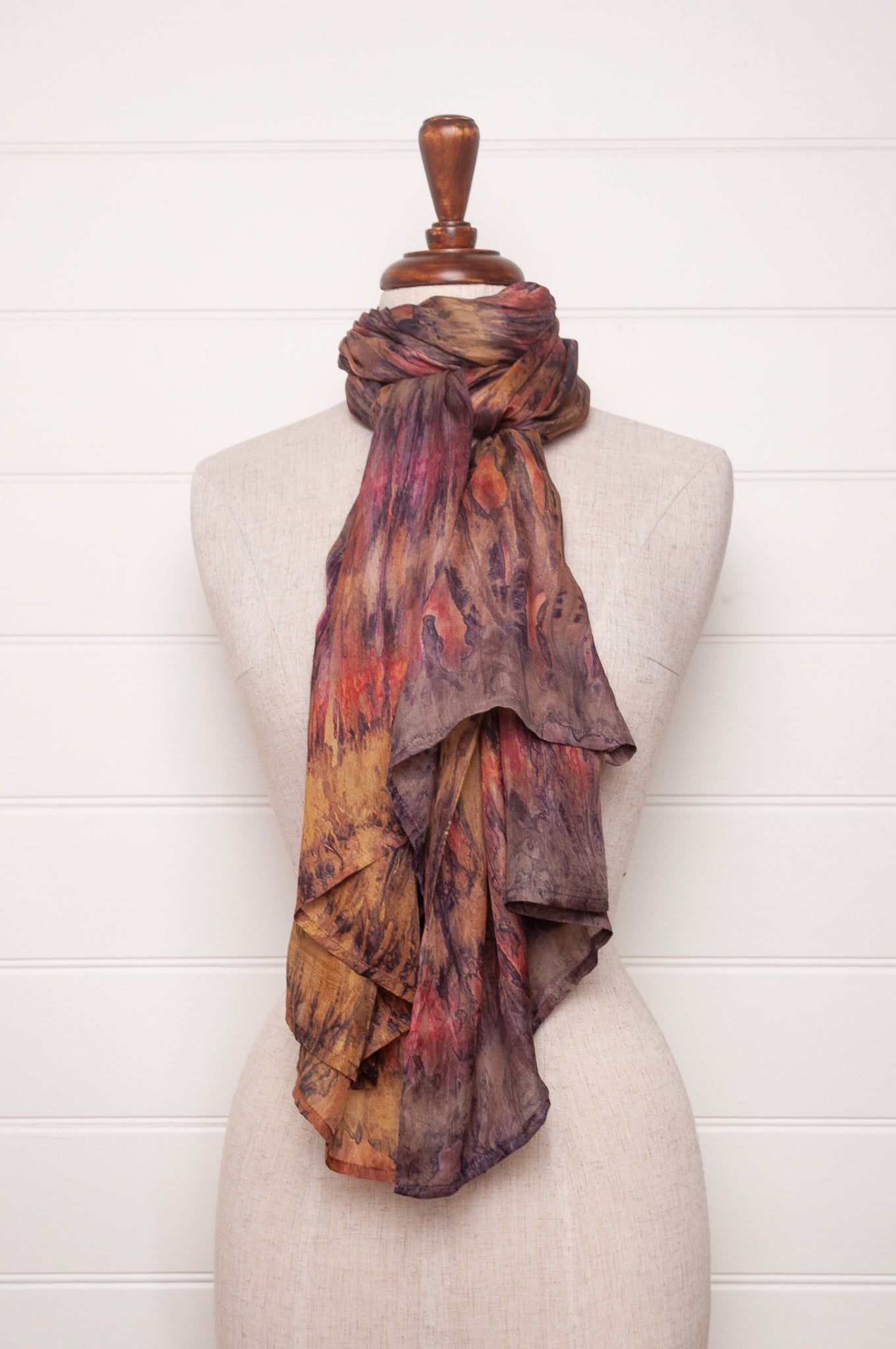 Pure silk shibori dyed scarf in shades of bronze, orange and purple.
