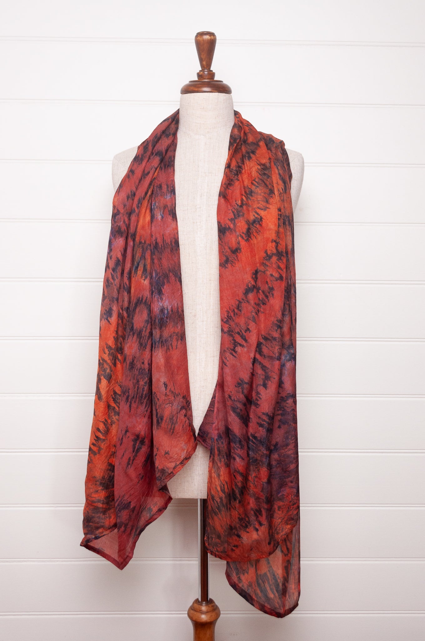 Pure silk shibori dyed scarf in shades of deep red, orange and brown.