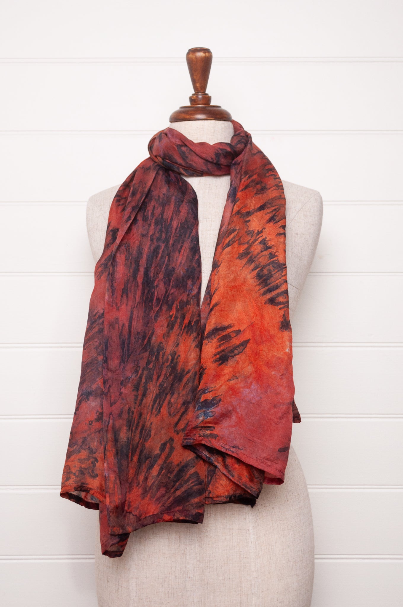 Pure silk shibori dyed scarf in shades of deep red, orange and brown.