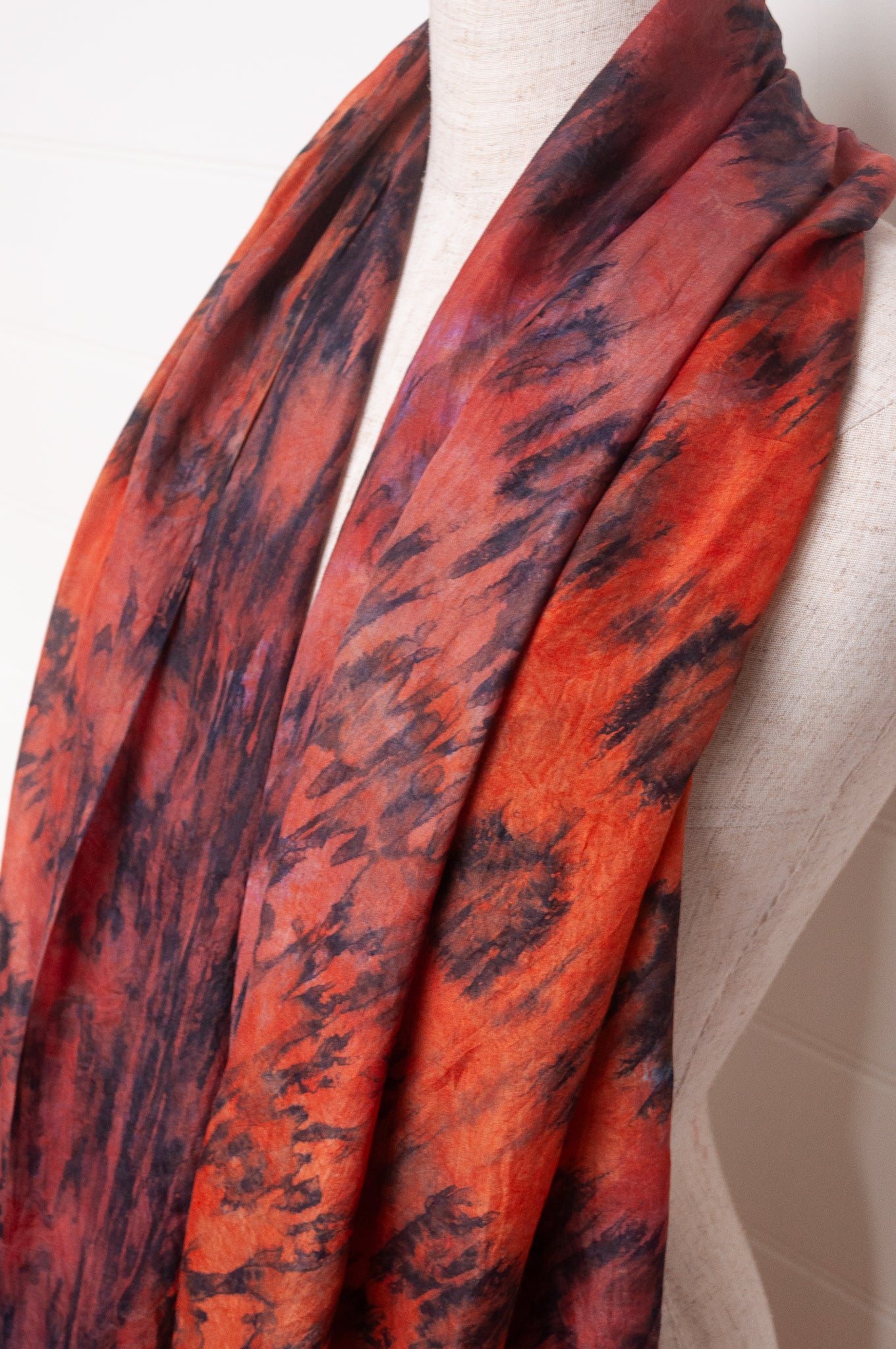 Pure silk shibori dyed scarf in shades of deep red, orange and brown.