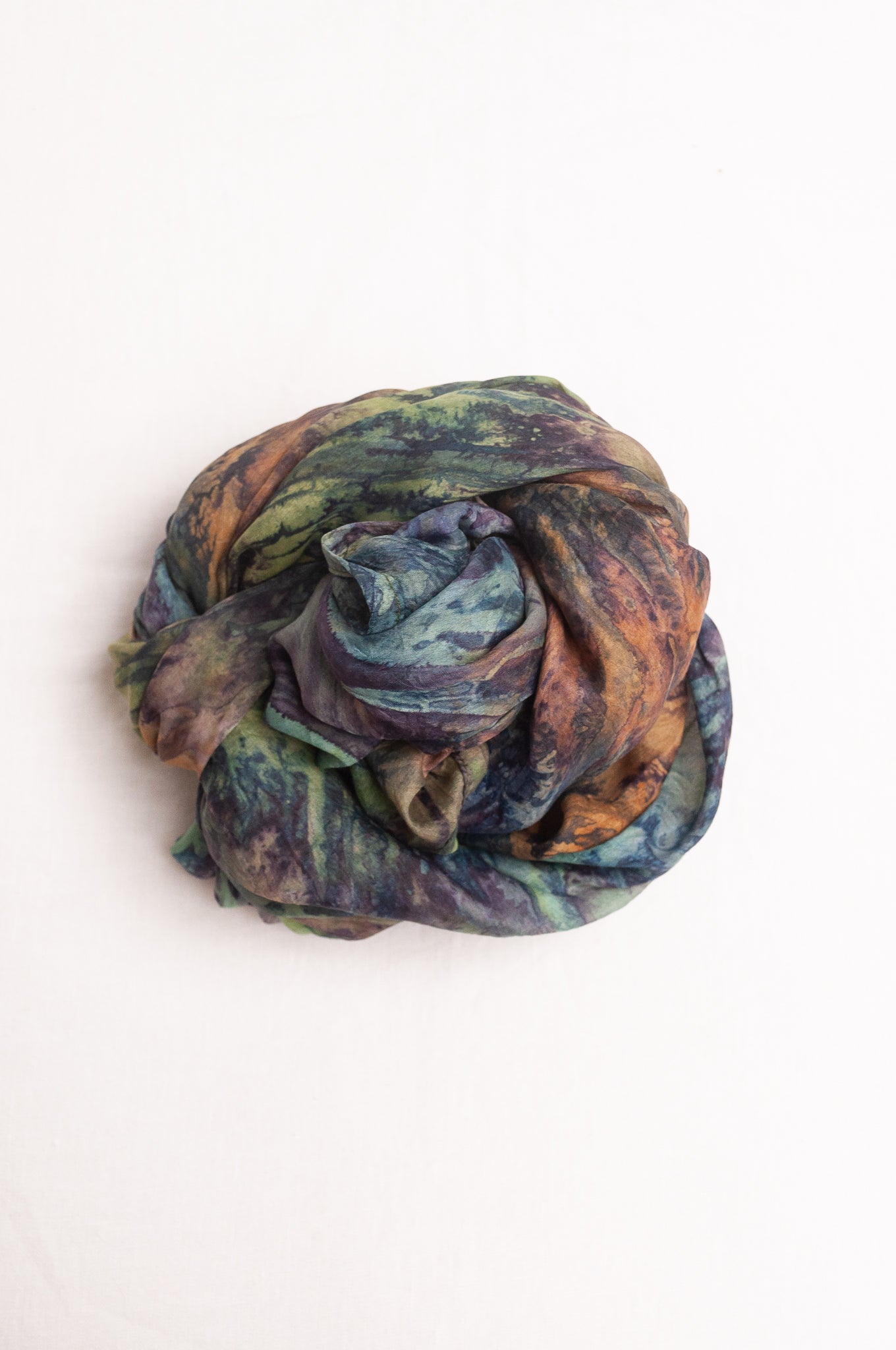 Pure silk shibori dyed scarf in shades of blues, greens and browns.