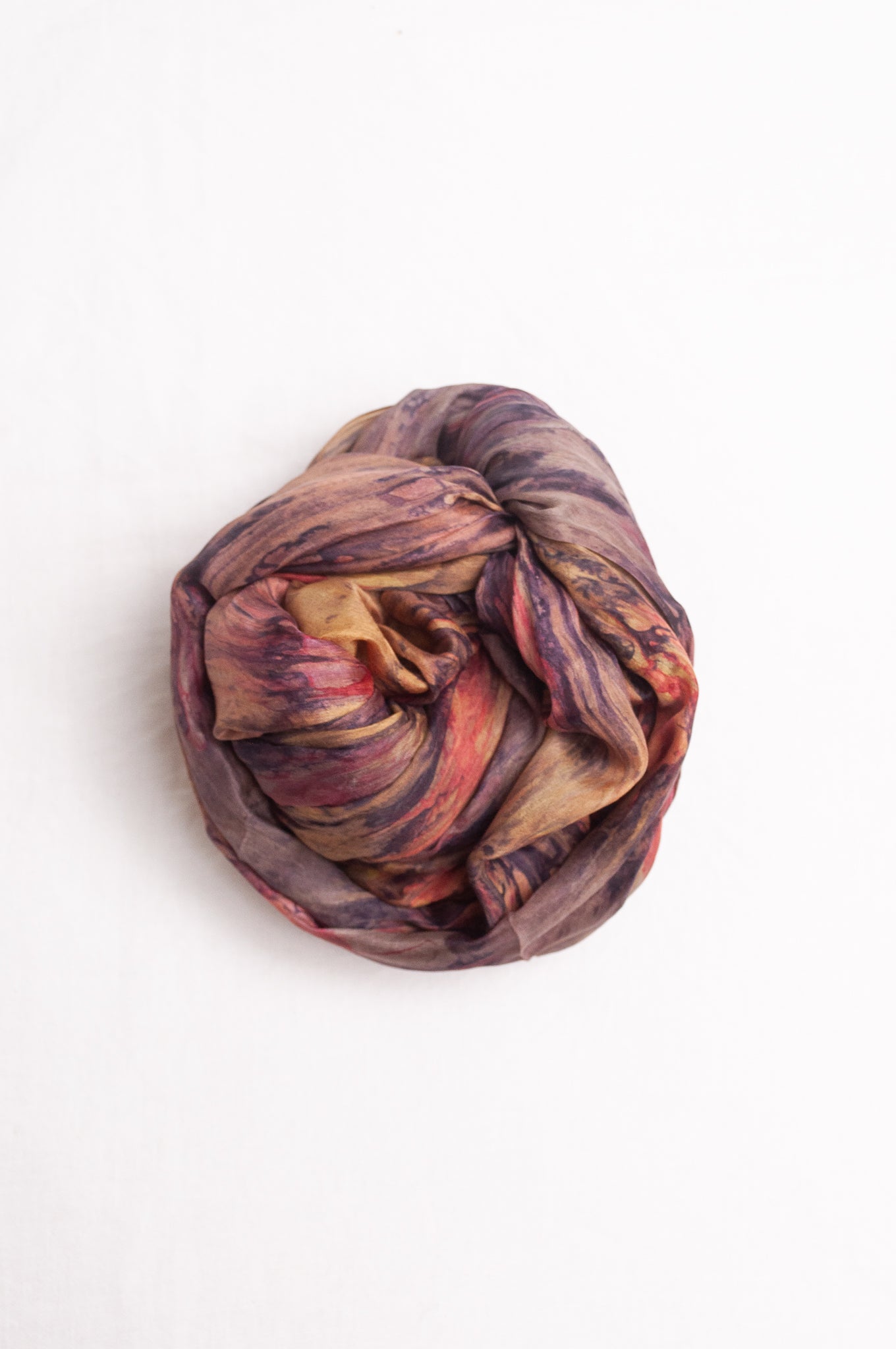 Pure silk shibori dyed scarf in shades of bronze, orange and purple.