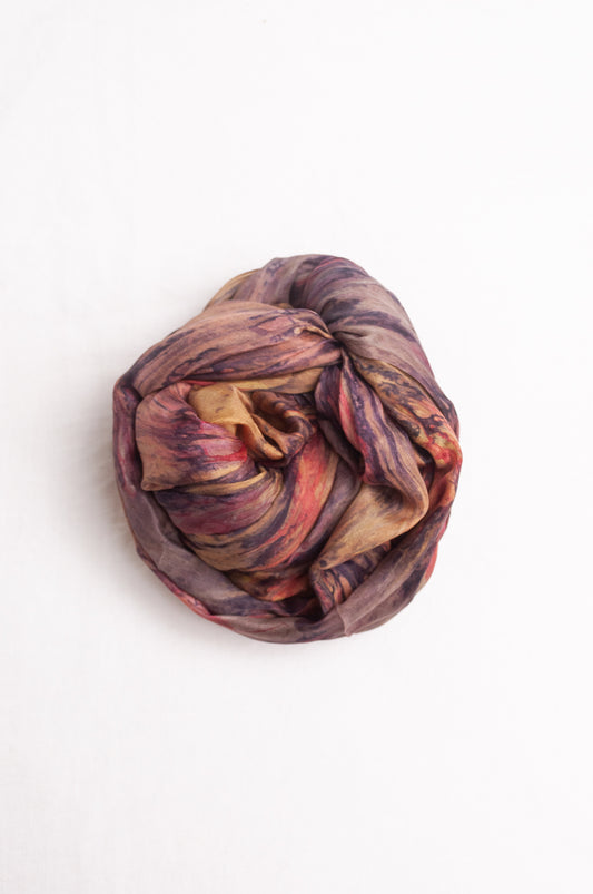 Pure silk shibori dyed scarf in shades of bronze, orange and purple.