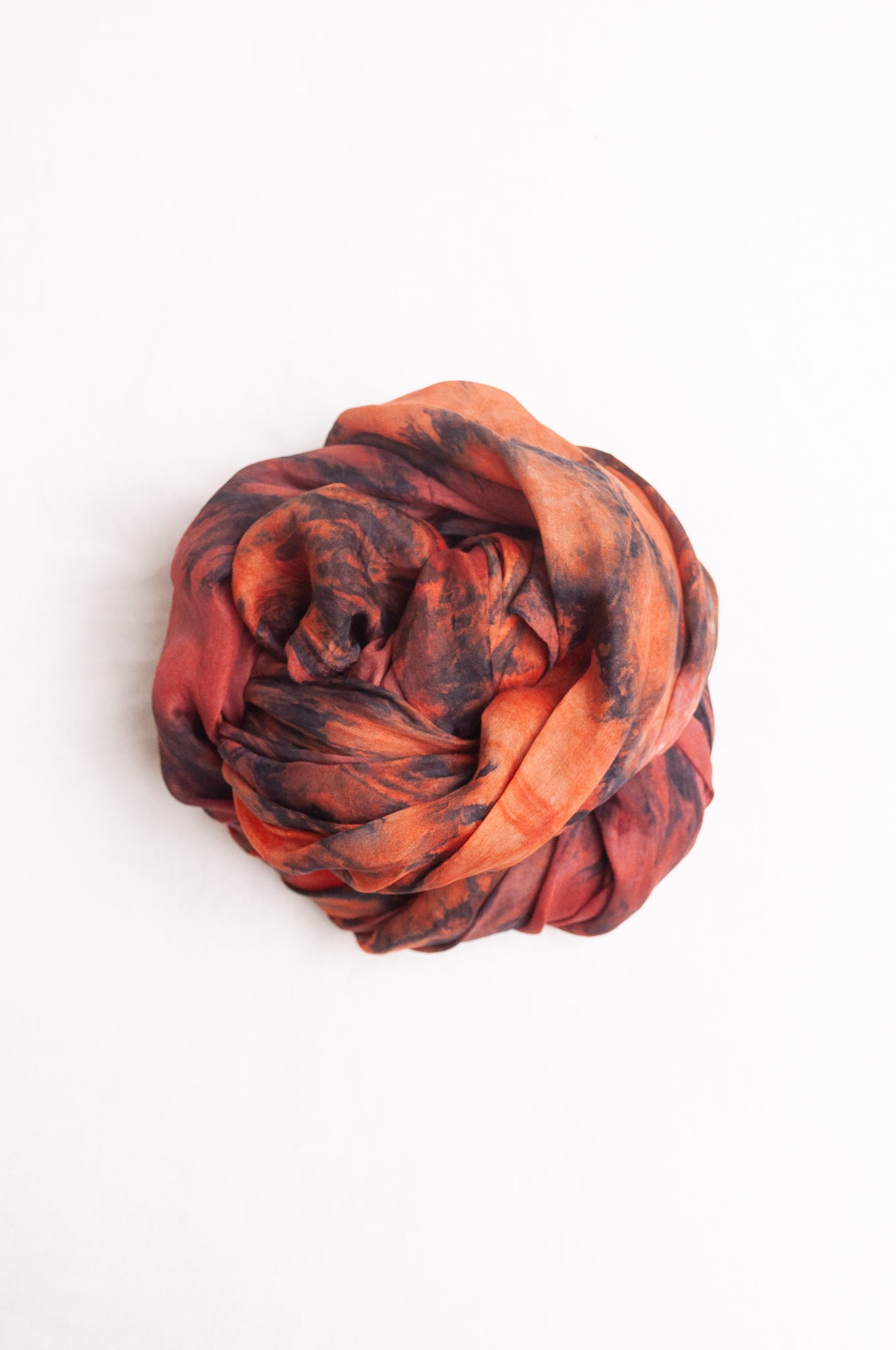 Pure silk shibori dyed scarf in shades of deep red, orange and brown.