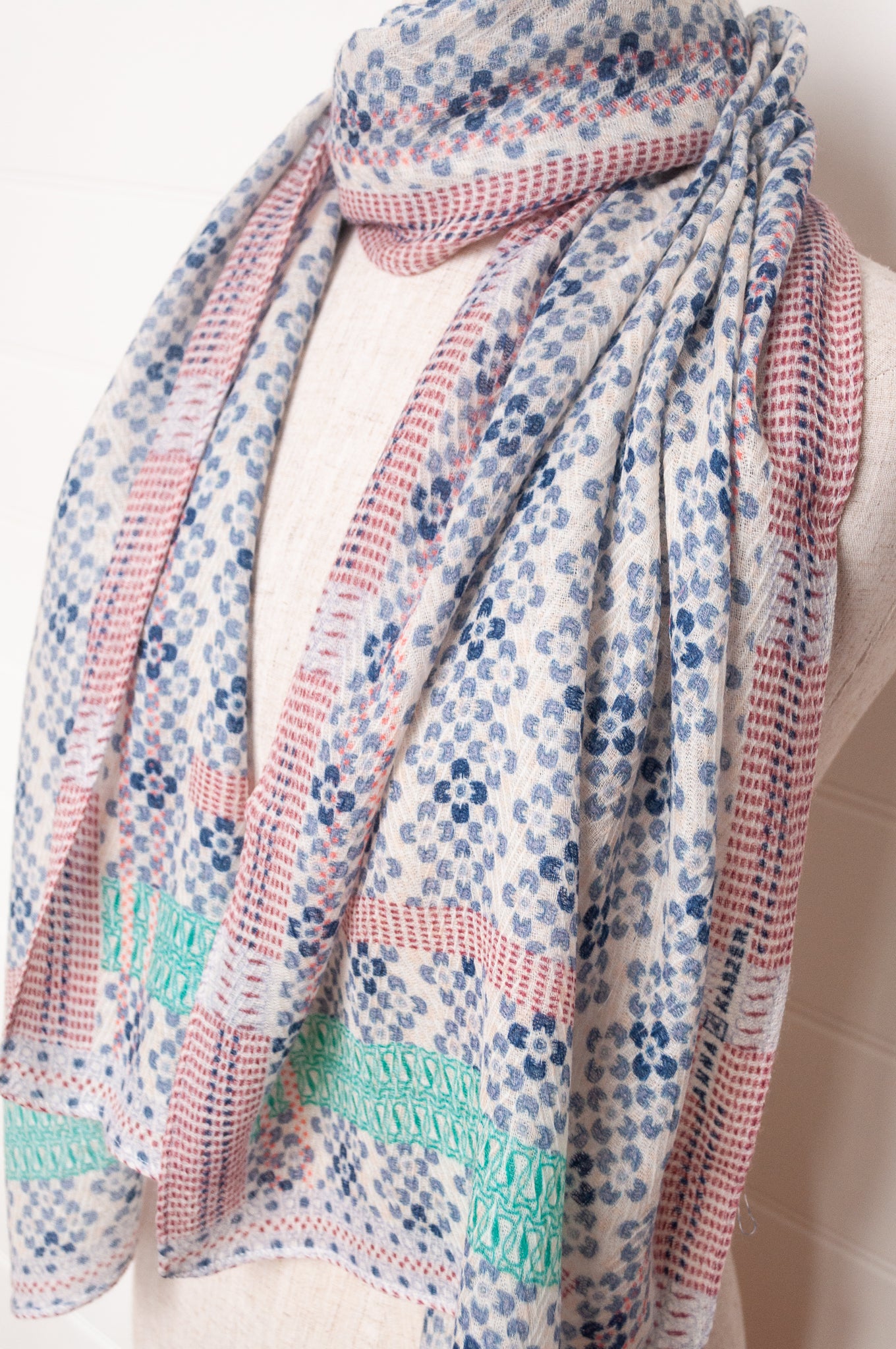 Anna Kaszer fine wool scarf Marti Inosa blue and white geometric flower pattern with green and red highlights.