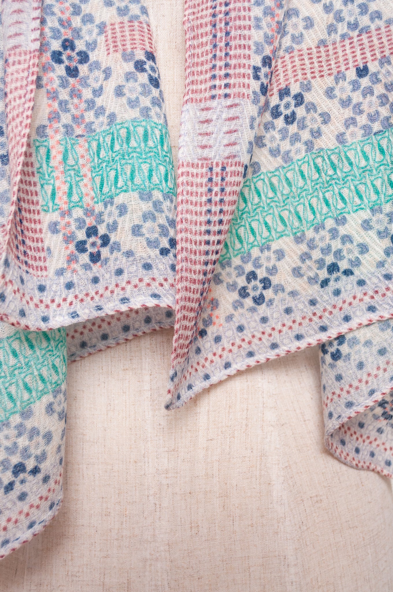 Anna Kaszer fine wool scarf Marti Inosa blue and white geometric flower pattern with green and red highlights.