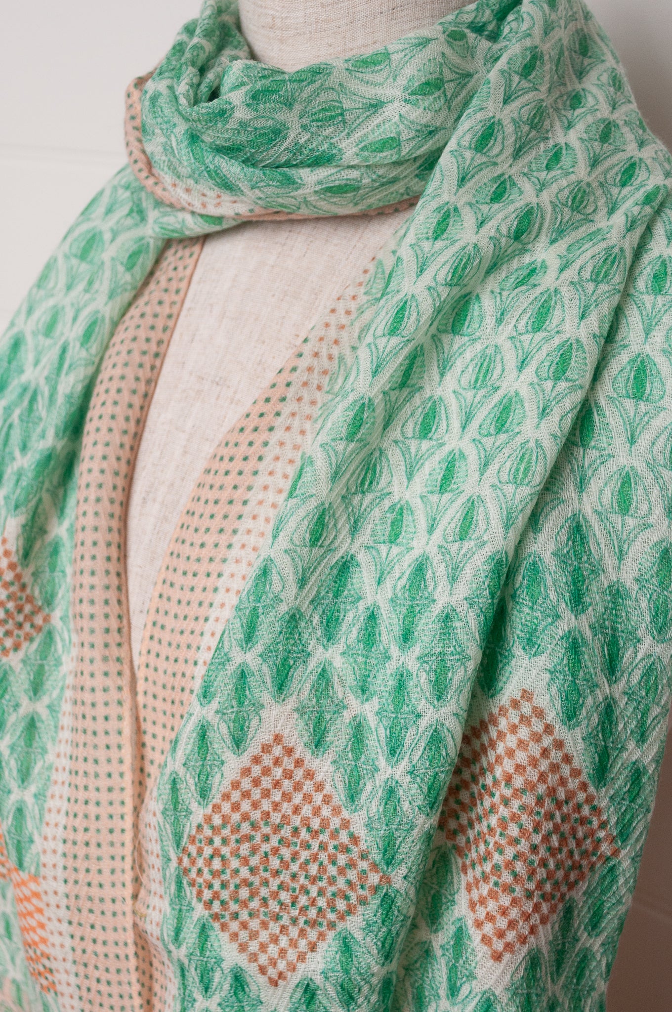 Anna Kaszer fine wool scarf Pouki tonic green and white geometric with coral highlights.