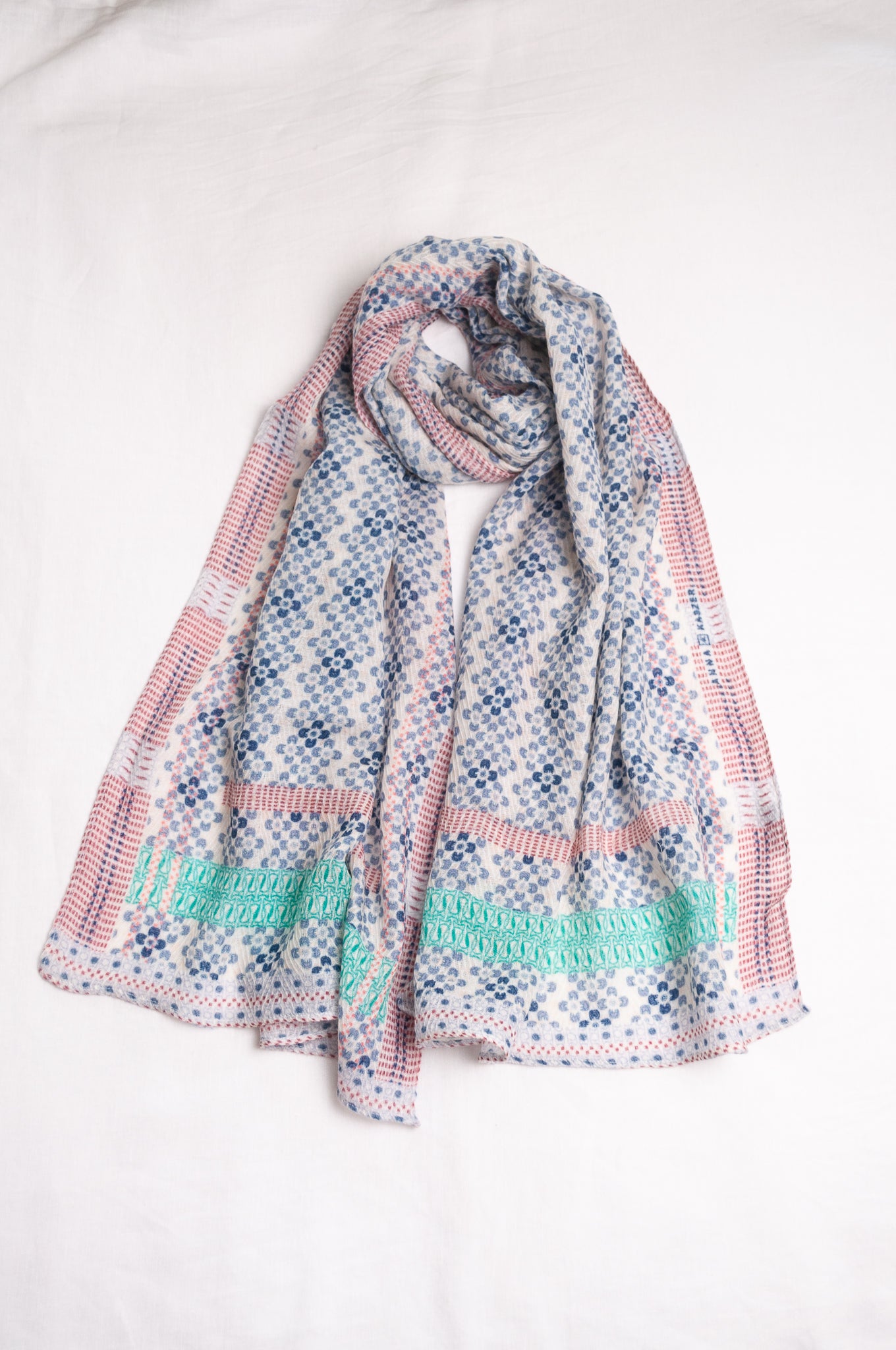 Anna Kaszer fine wool scarf Marti Inosa blue and white geometric flower pattern with green and red highlights.