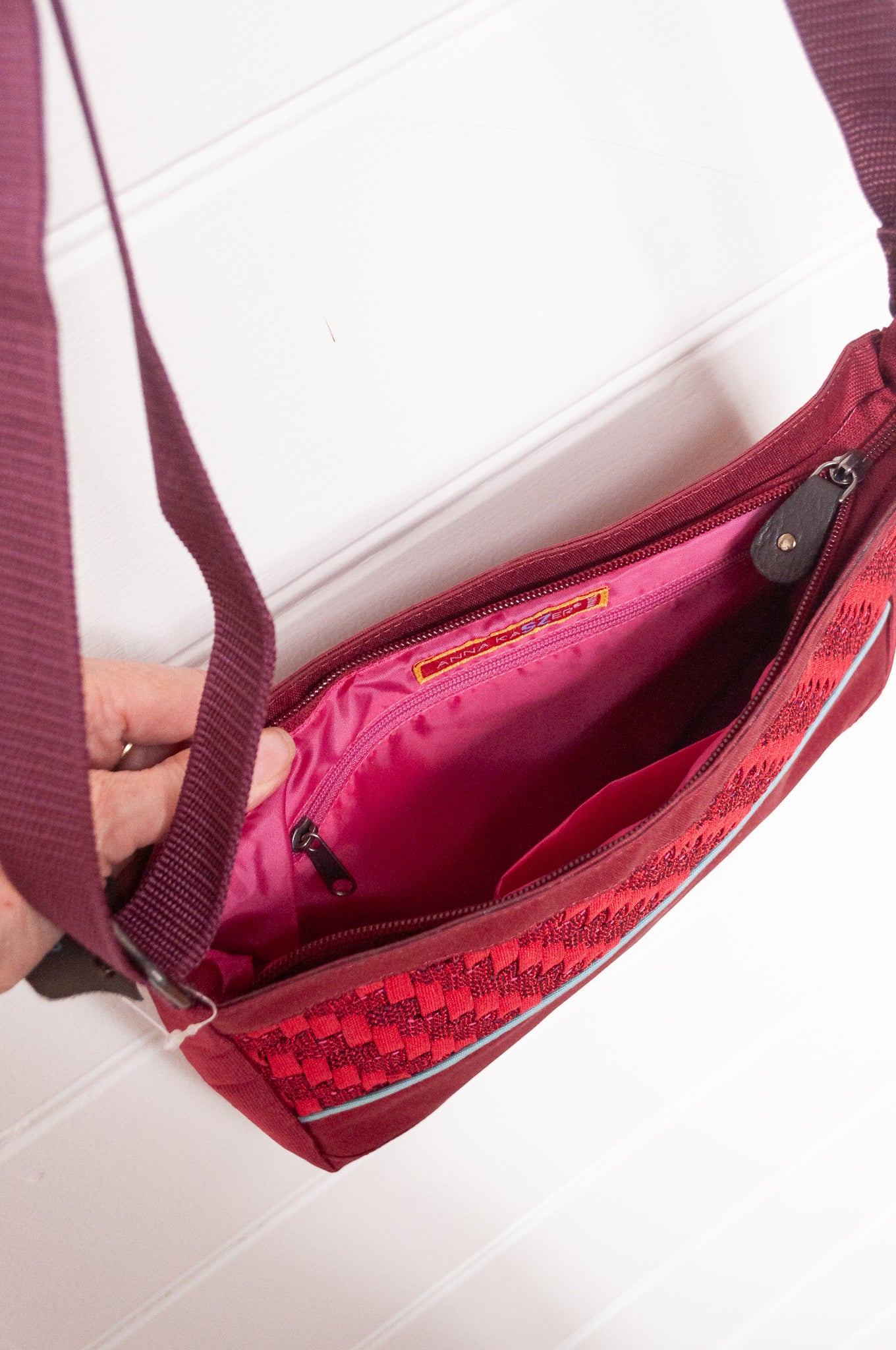 Anna Kaszer Loli red Taki cross body bag with woven braid panel.
