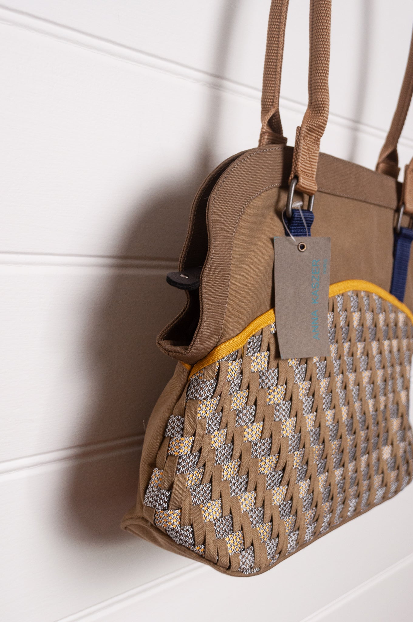 Anna Kaszer Fox bag in taupe, with double shoulder straps and woven braid panel.