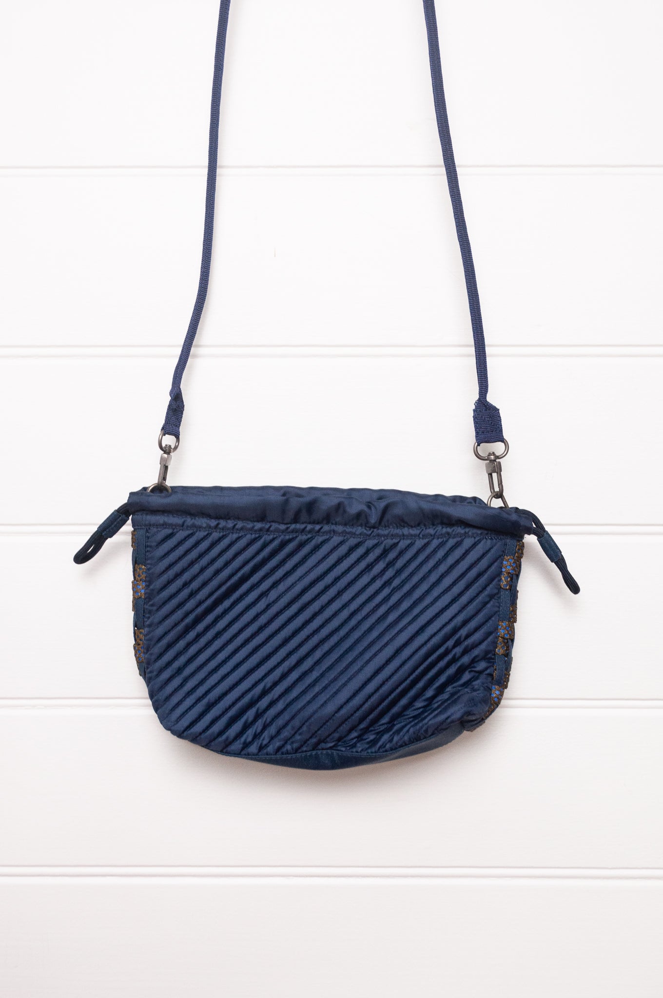 Anna Kaszer quilted Oko drawstring small bag in deep navy Night blue, with woven braid panel.