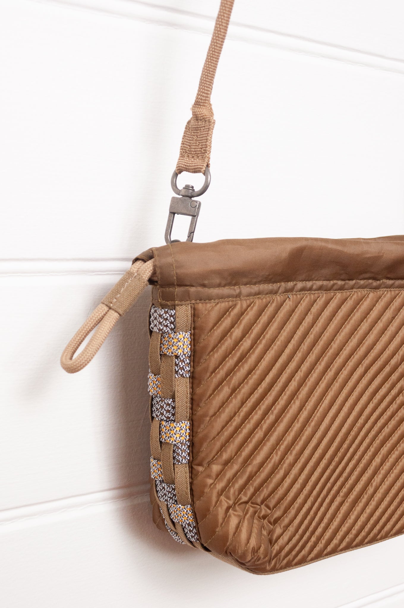 Anna Kaszer quilted drawstring pouch bag in taupe.