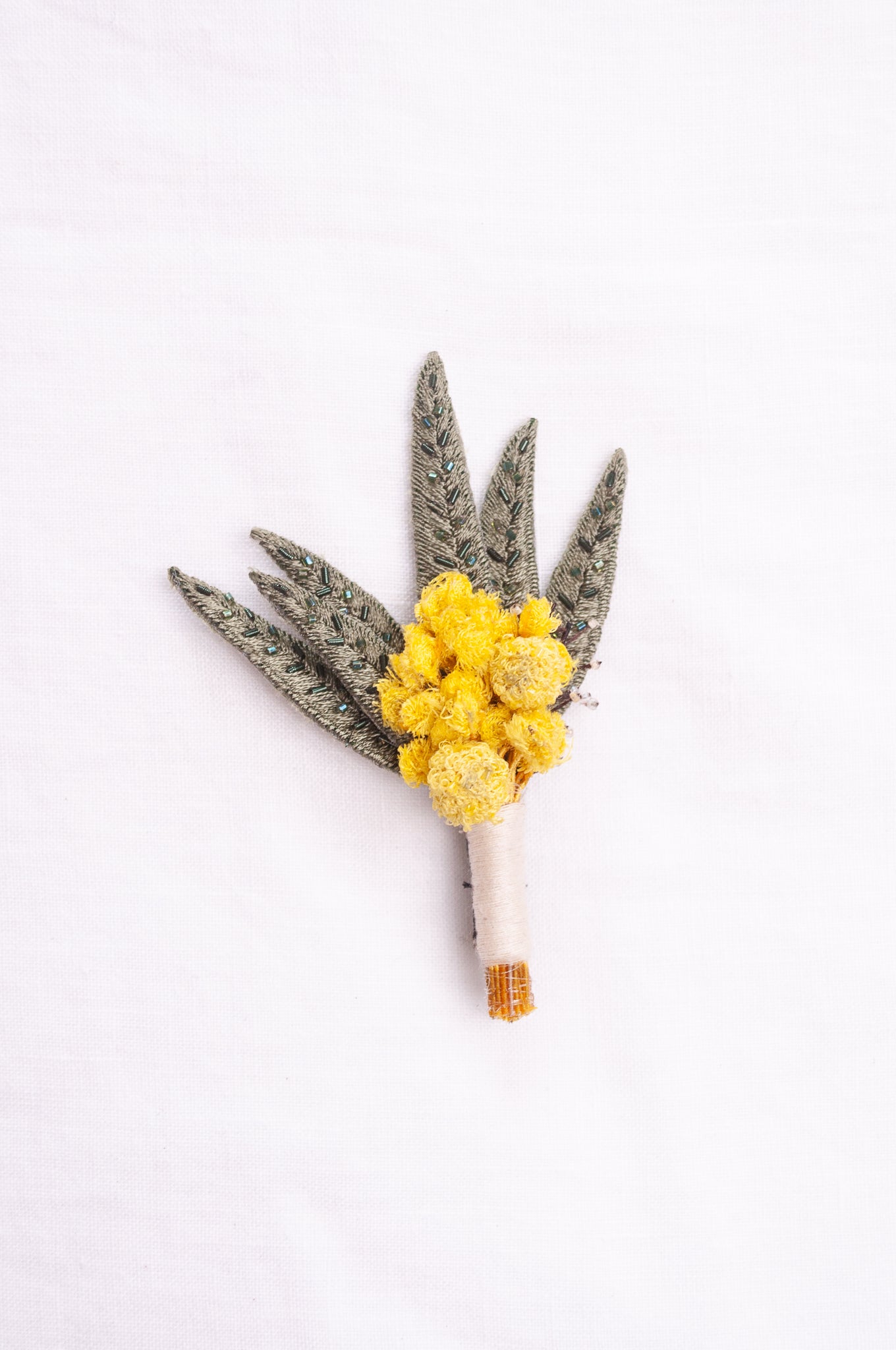 Trovelore hand embroidered and beaded Mimosa boutonniere brooch.