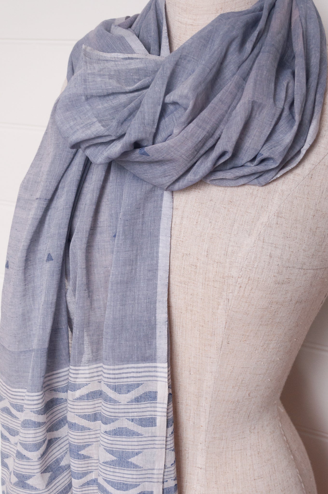 Handwoven light cotton light indigo panelled jamdani scarf with stripes and border motifs.