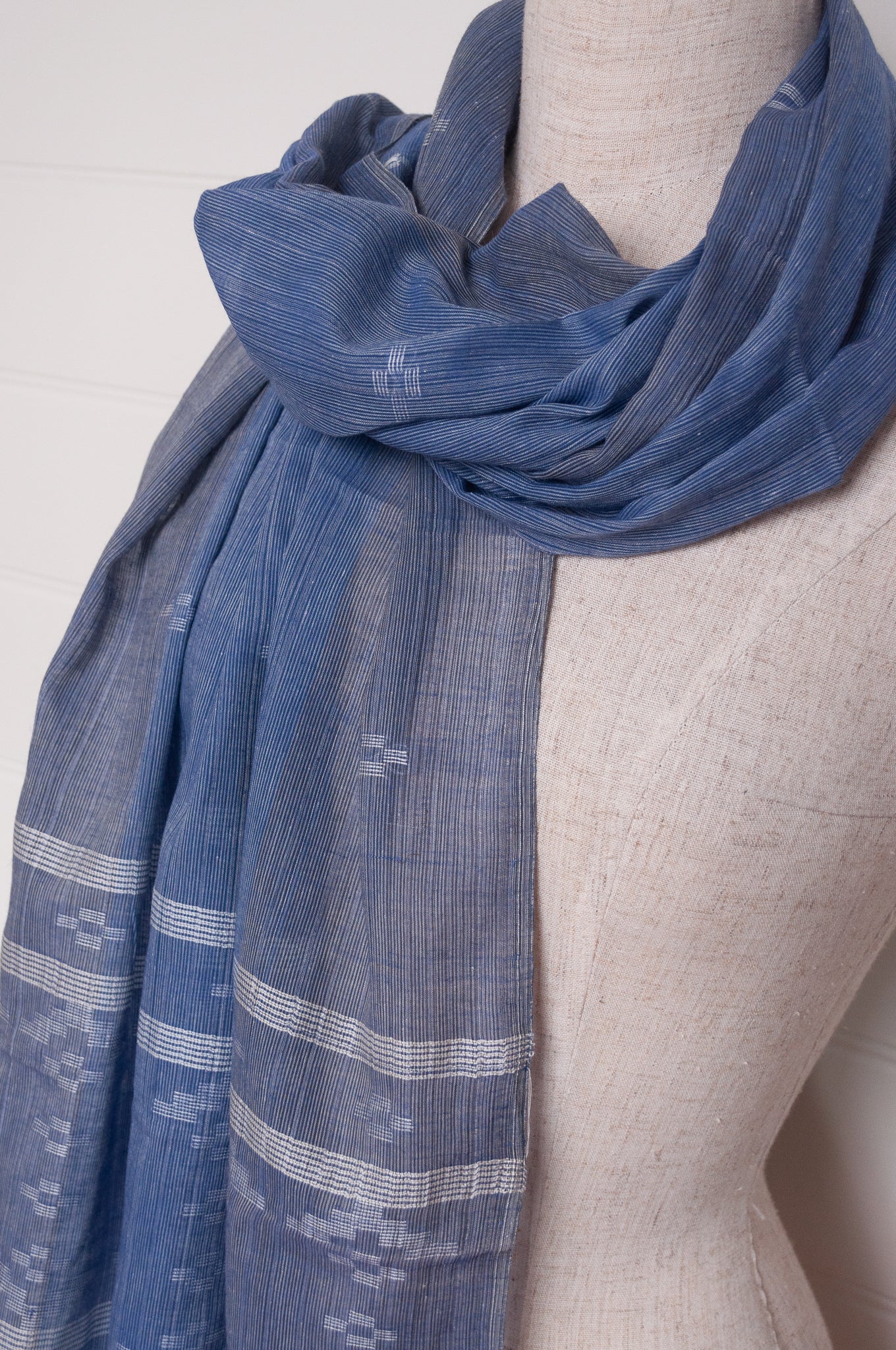 Handwoven light cotton  indigo panelled jamdani scarf with stripes and motifs in white.
