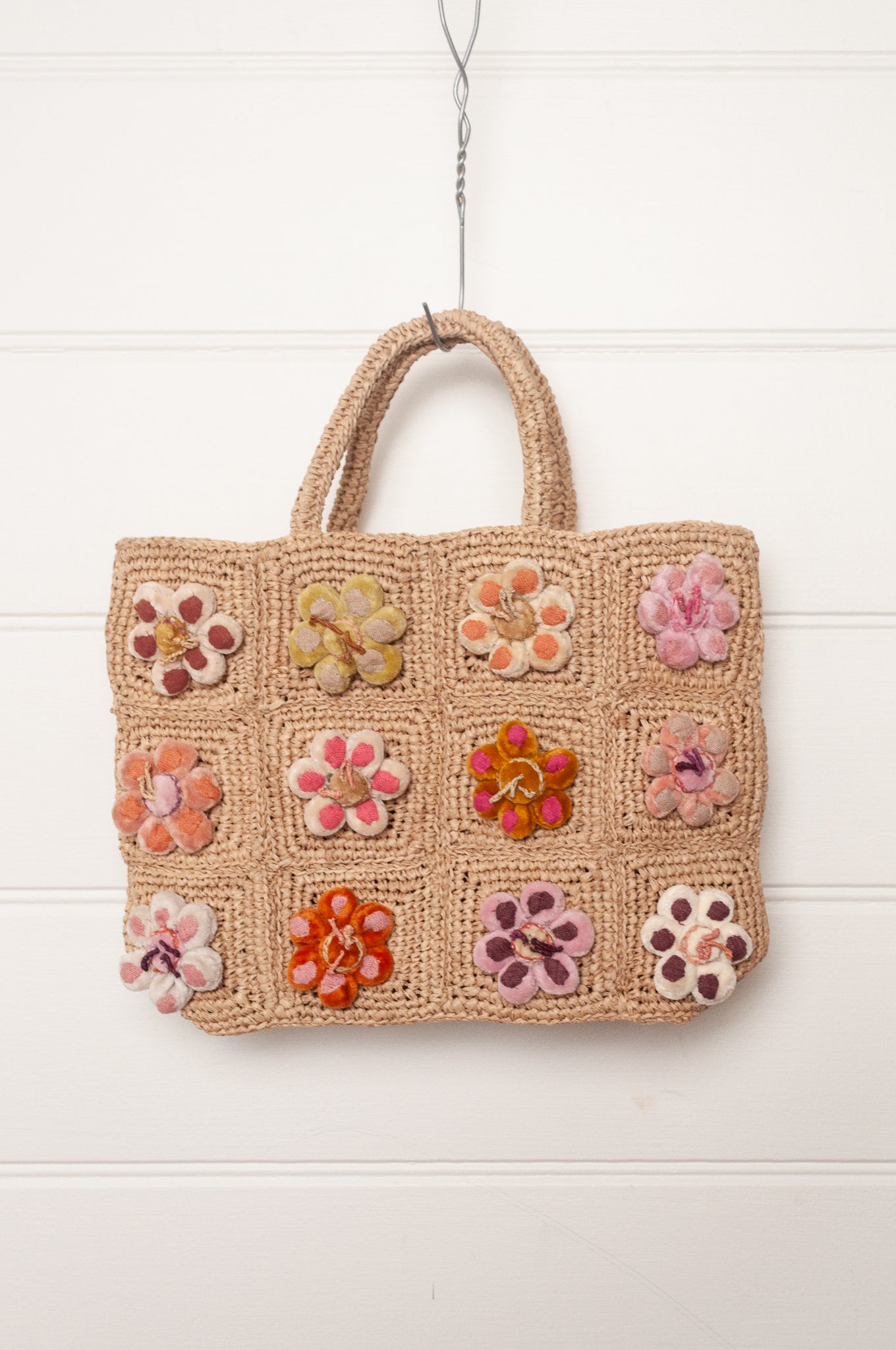 Sophie Digard crochet raffia bag in natural with pastel embroidered velvet flowers.