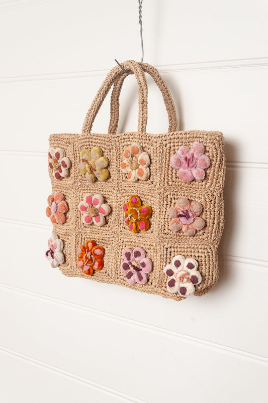 Sophie Digard crochet raffia bag in natural with pastel embroidered velvet flowers.
