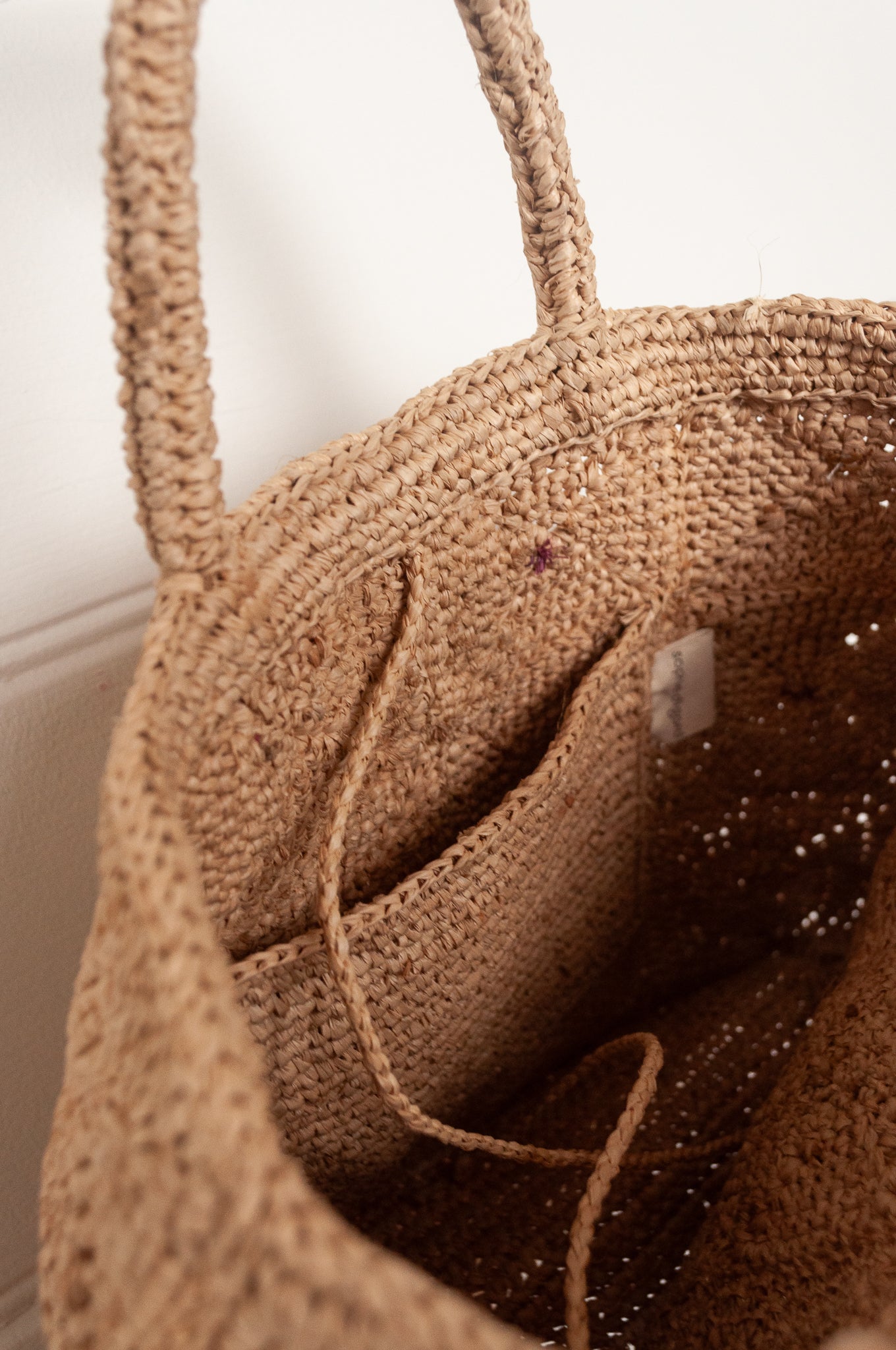 Sophie Digard crochet raffia bag in natural with pastel embroidered velvet flowers.