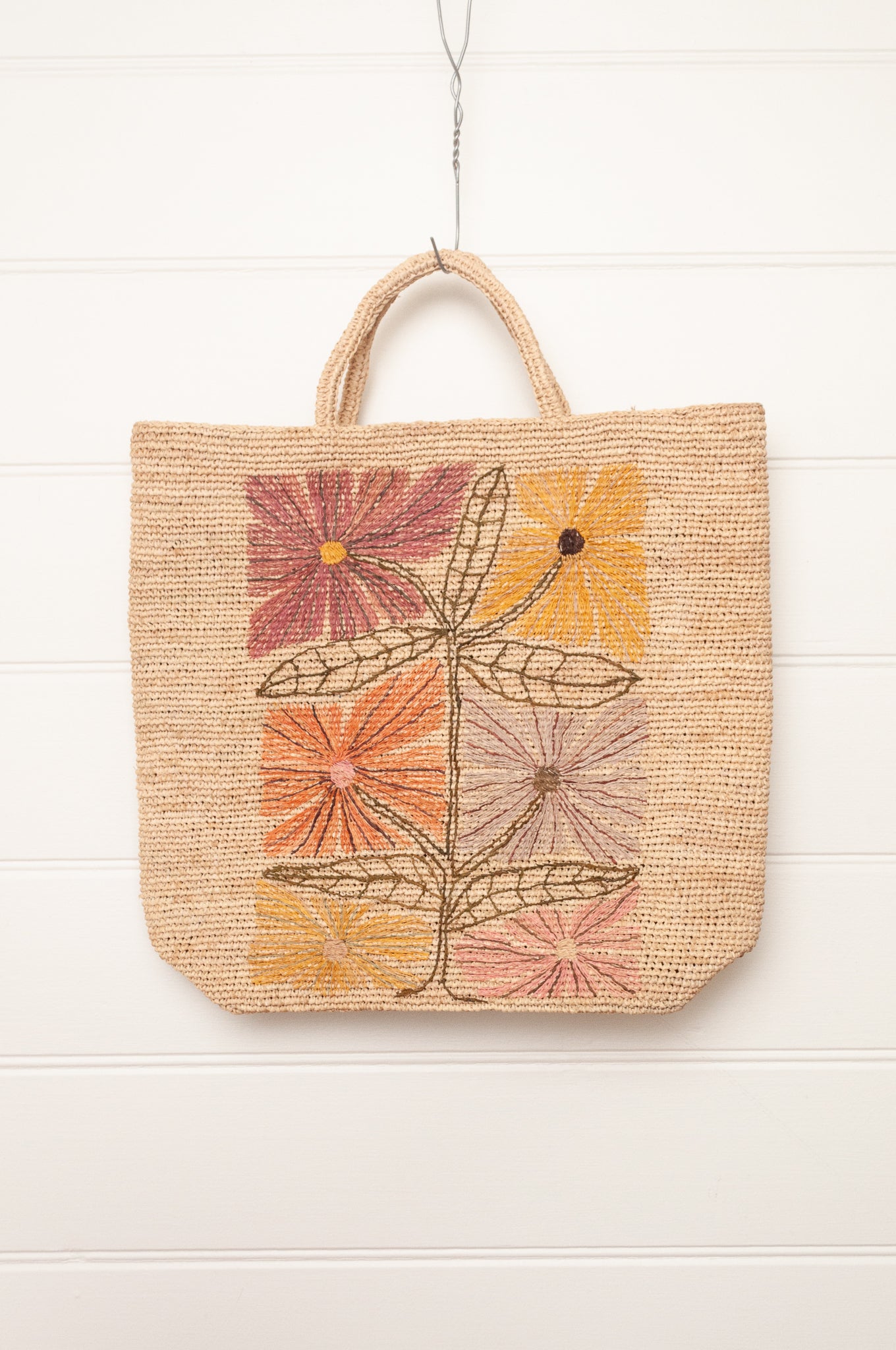 Sophie Digard natural coloured large tote bag with large flowers embroidered in warm neutral tones.