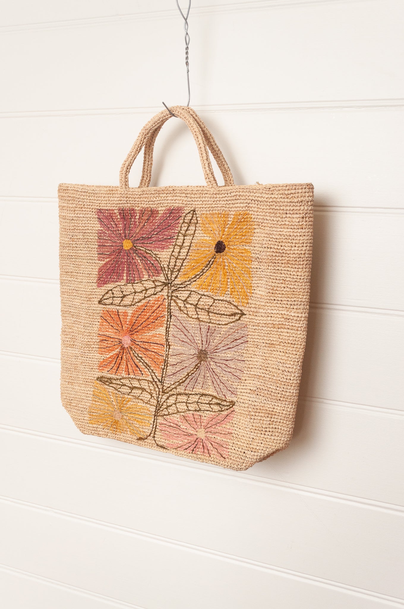 Sophie Digard natural coloured large tote bag with large flowers embroidered in warm neutral tones.